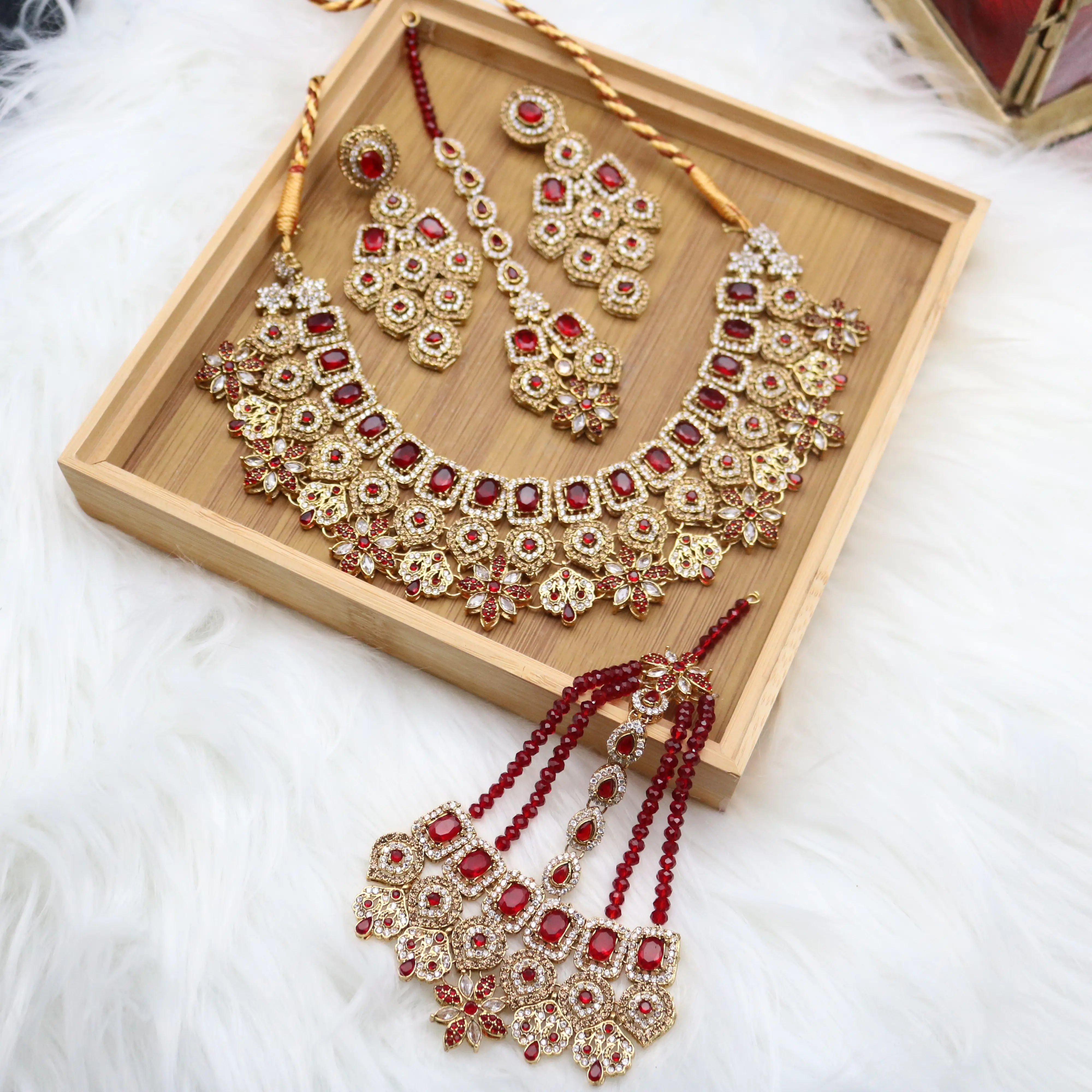 Gold-plated bridal jewelry with American diamonds and red stones