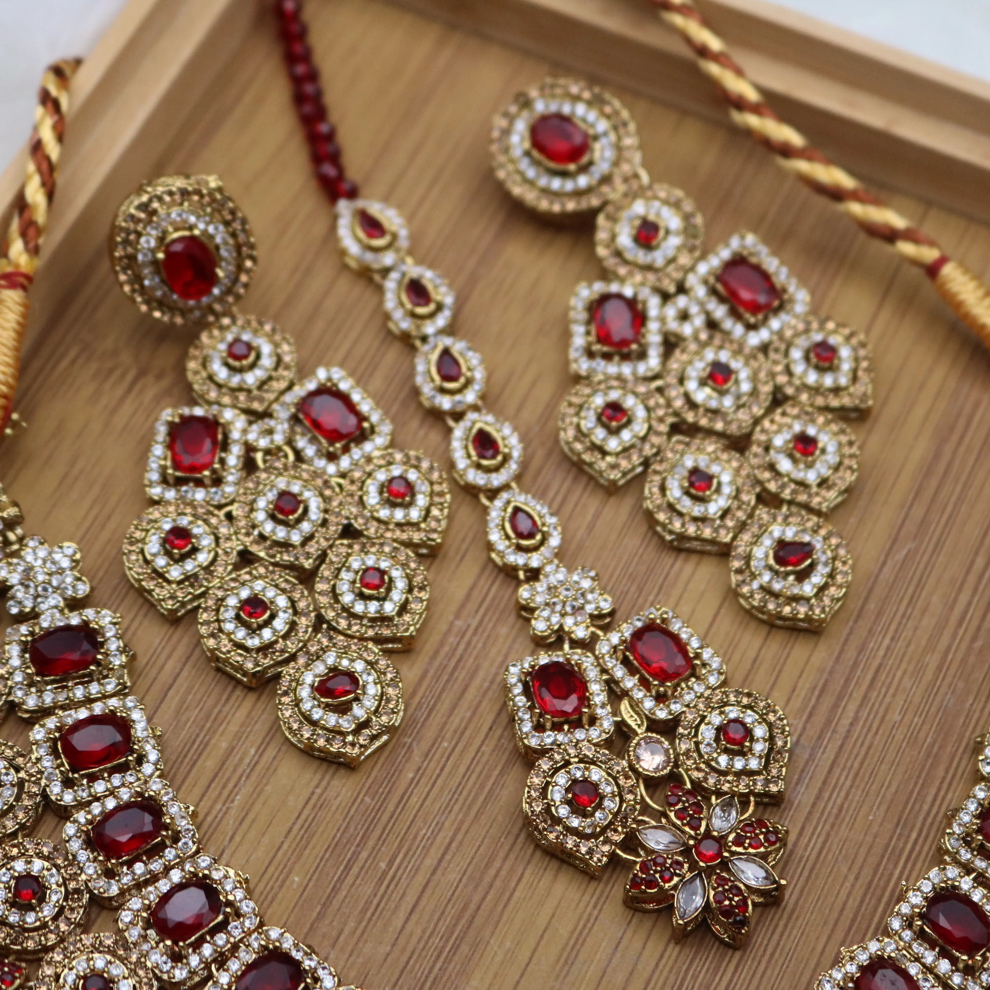 earring and teeka view of Red Pakistani bridal necklace set with earrings, teeka & jhoomer