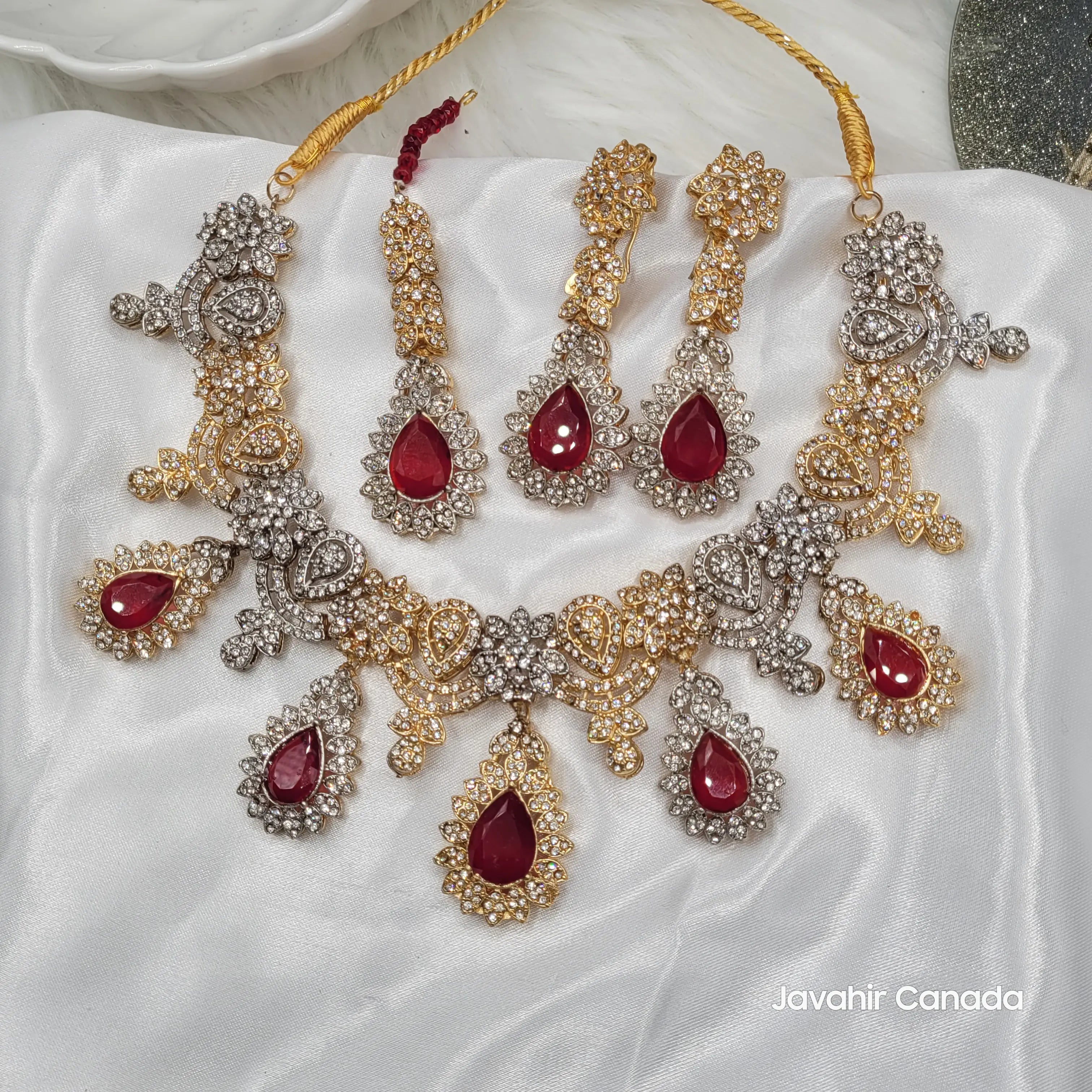 Top-down image of JV155 necklace set showcasing symmetrical layout and floral CZ settings.