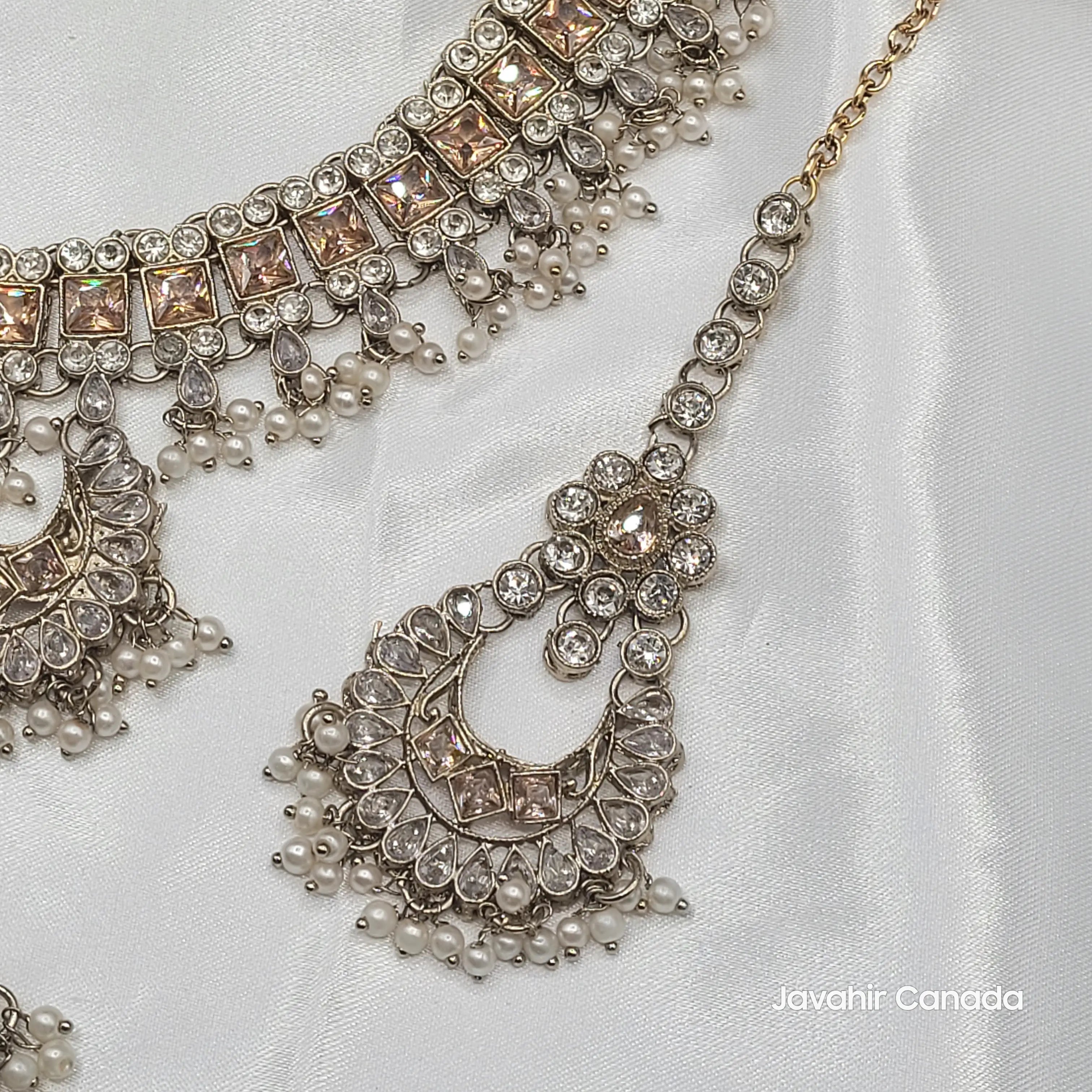 Close-up of JV156 tikka showcasing antique silver finish and kundan work with pearl drops.