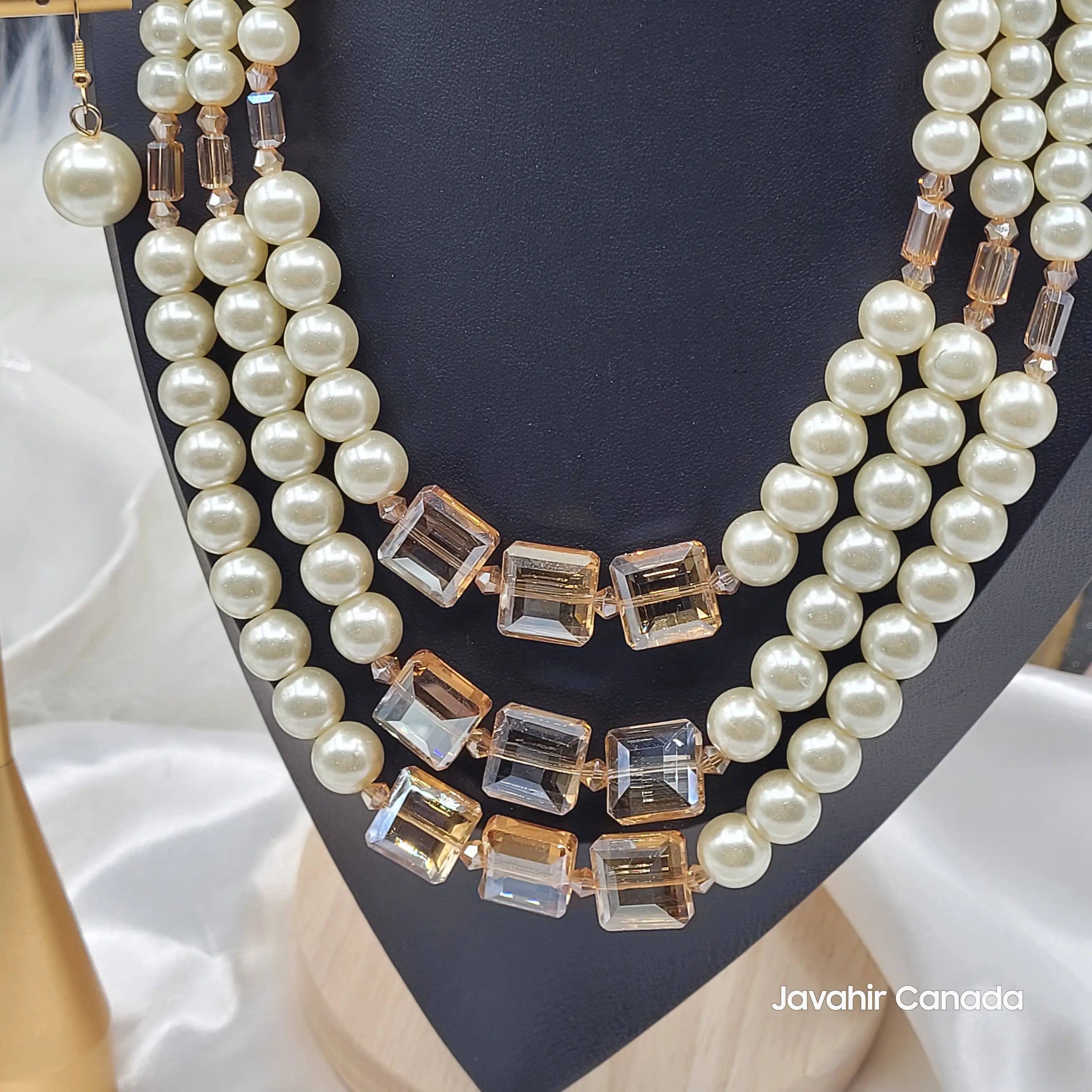 Close-up of JV160 in Ivory Gold showing clear champagne-cut square crystals