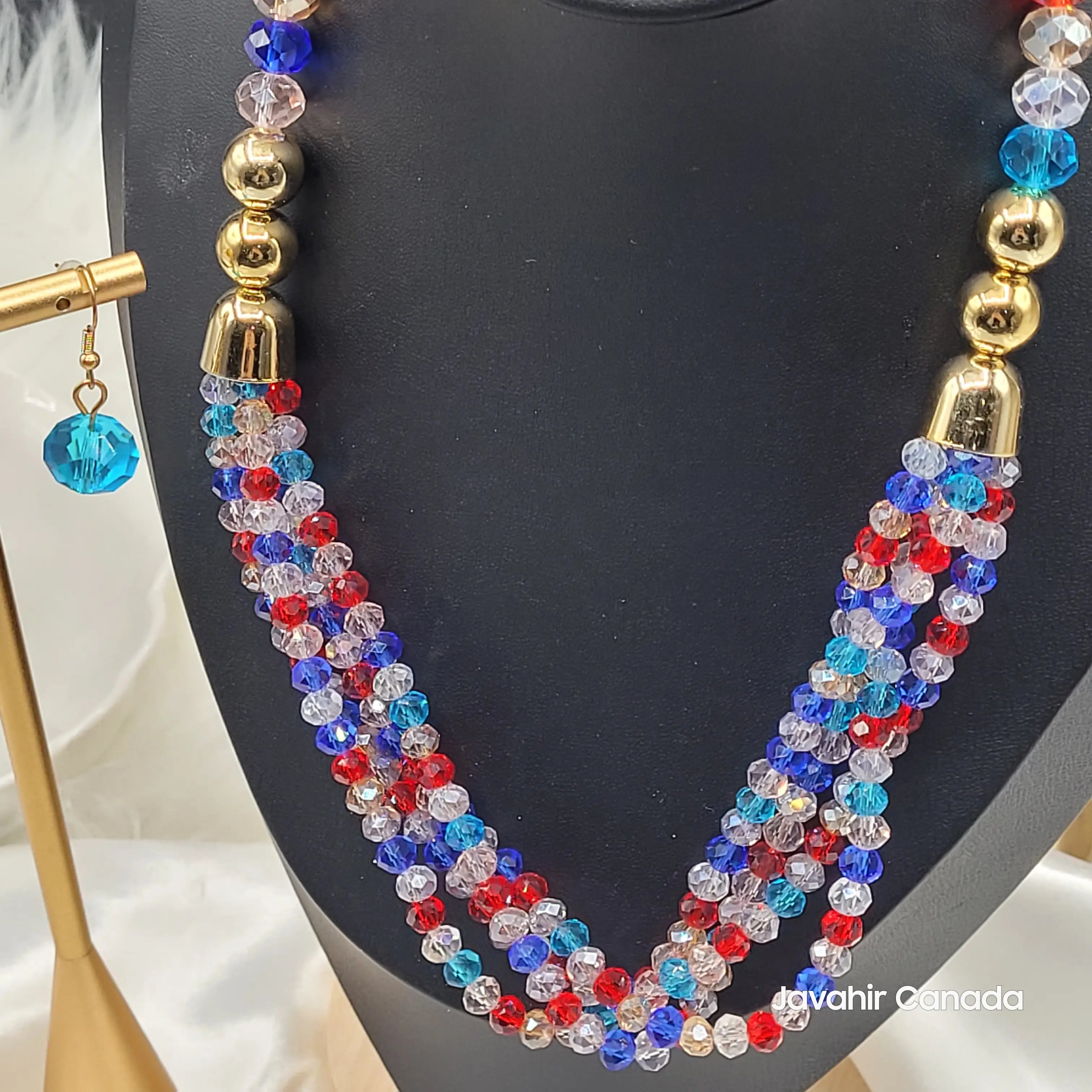 Close-up of the red-blue multicolor JV161 necklace showing intricate beadwork, shimmering crystal texture, and twisted strand detailing. Matching earring displayed in foreground.