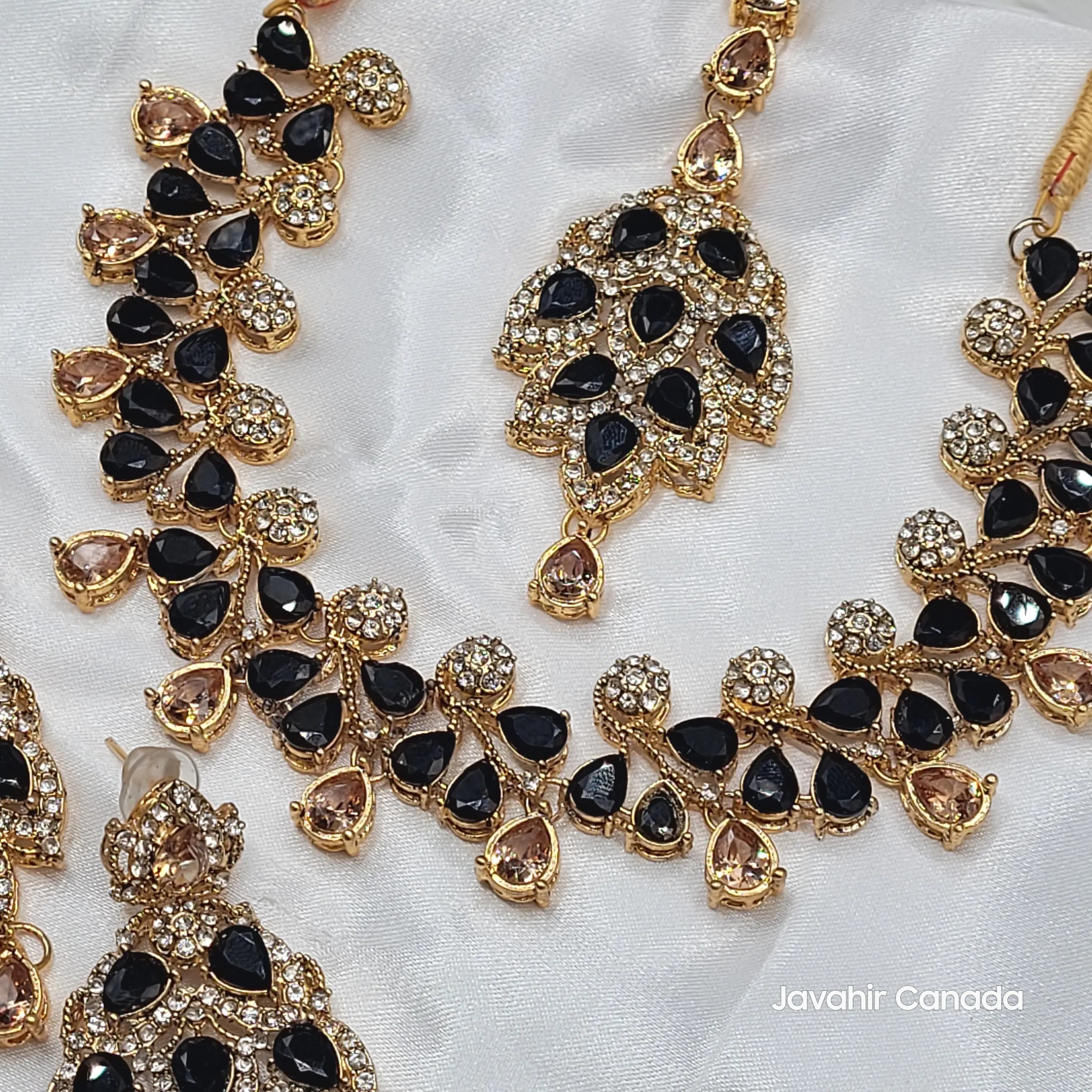 Detailed view of JV20 necklace pendant featuring black and champagne stones