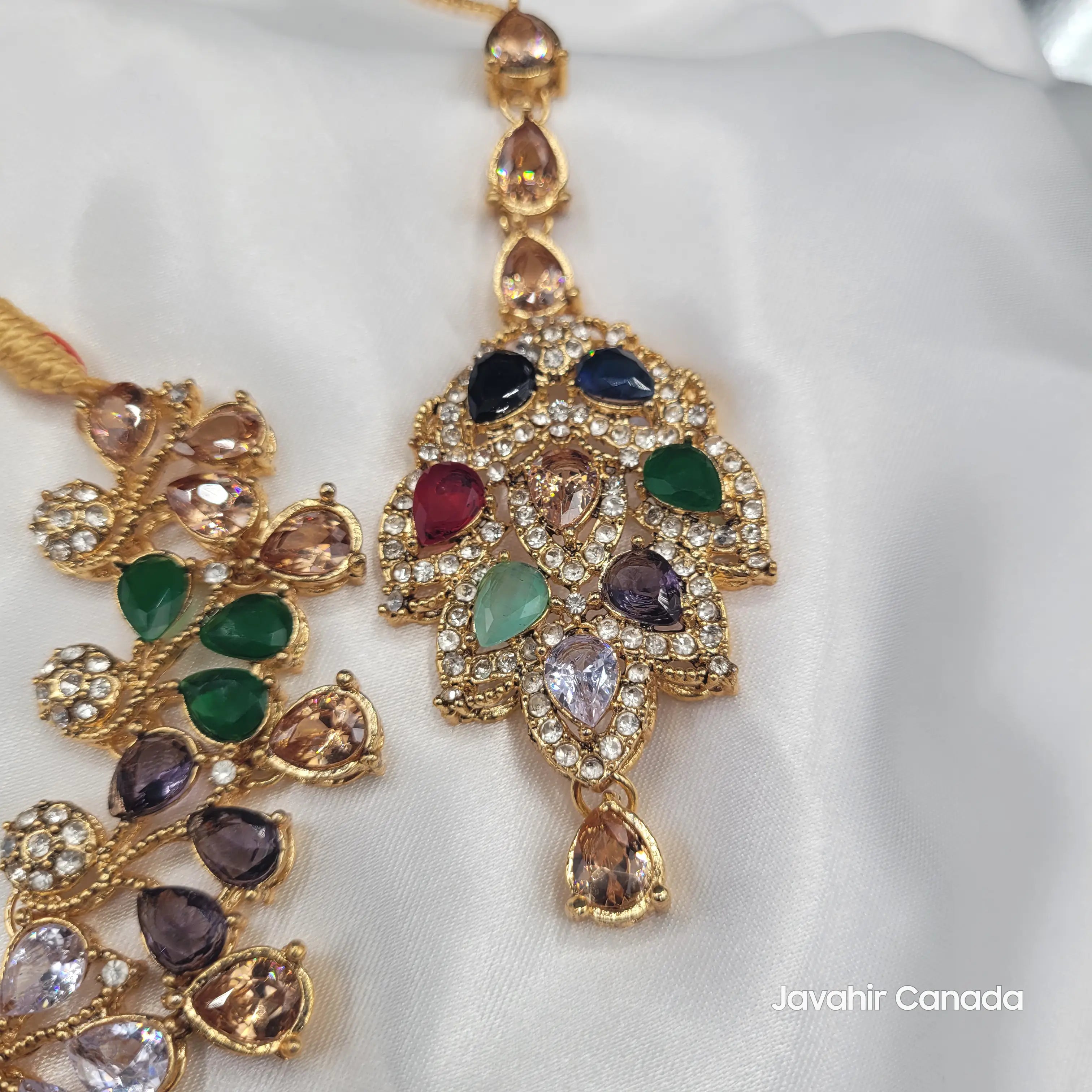 Close-up of JV20 teeka featuring multicolor CZ stones in floral gold design