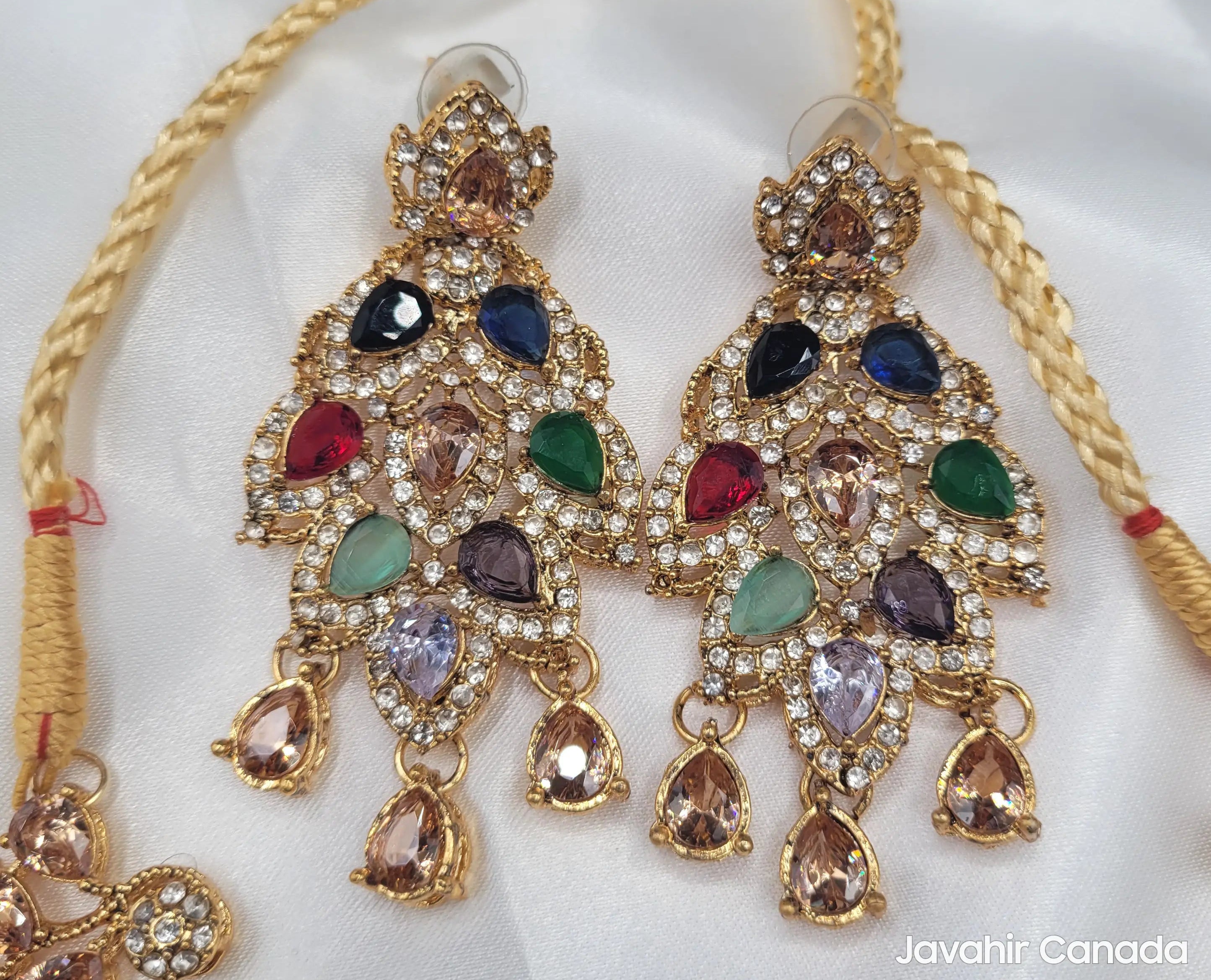 Multicolor JV20 earrings with pear-shaped CZ gemstones in red, blue, green, and champagne tones on a white background.