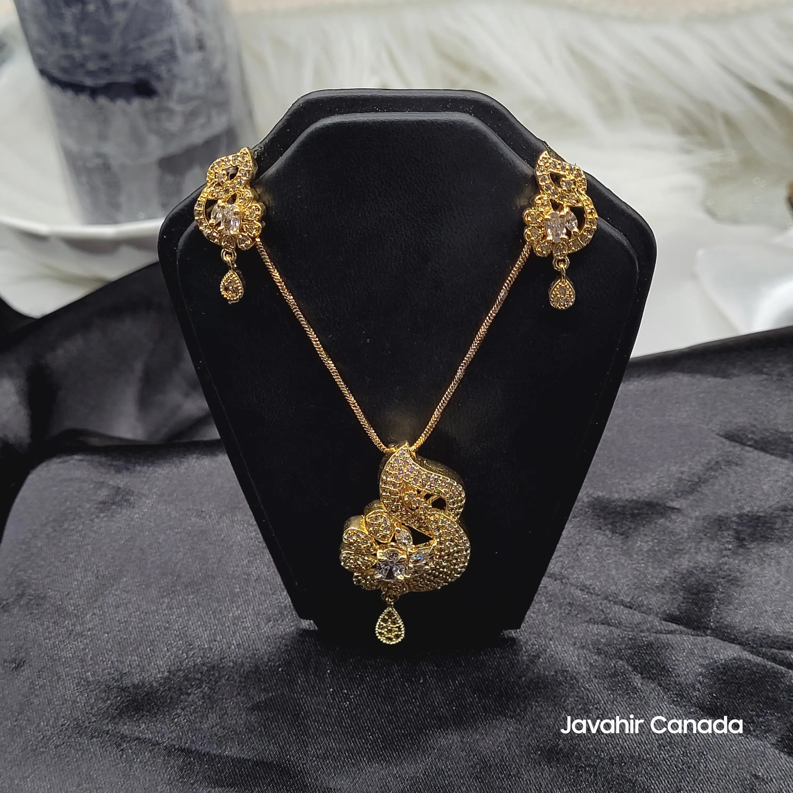 Gold plated abstract motif pendant set with teardrop AD accents