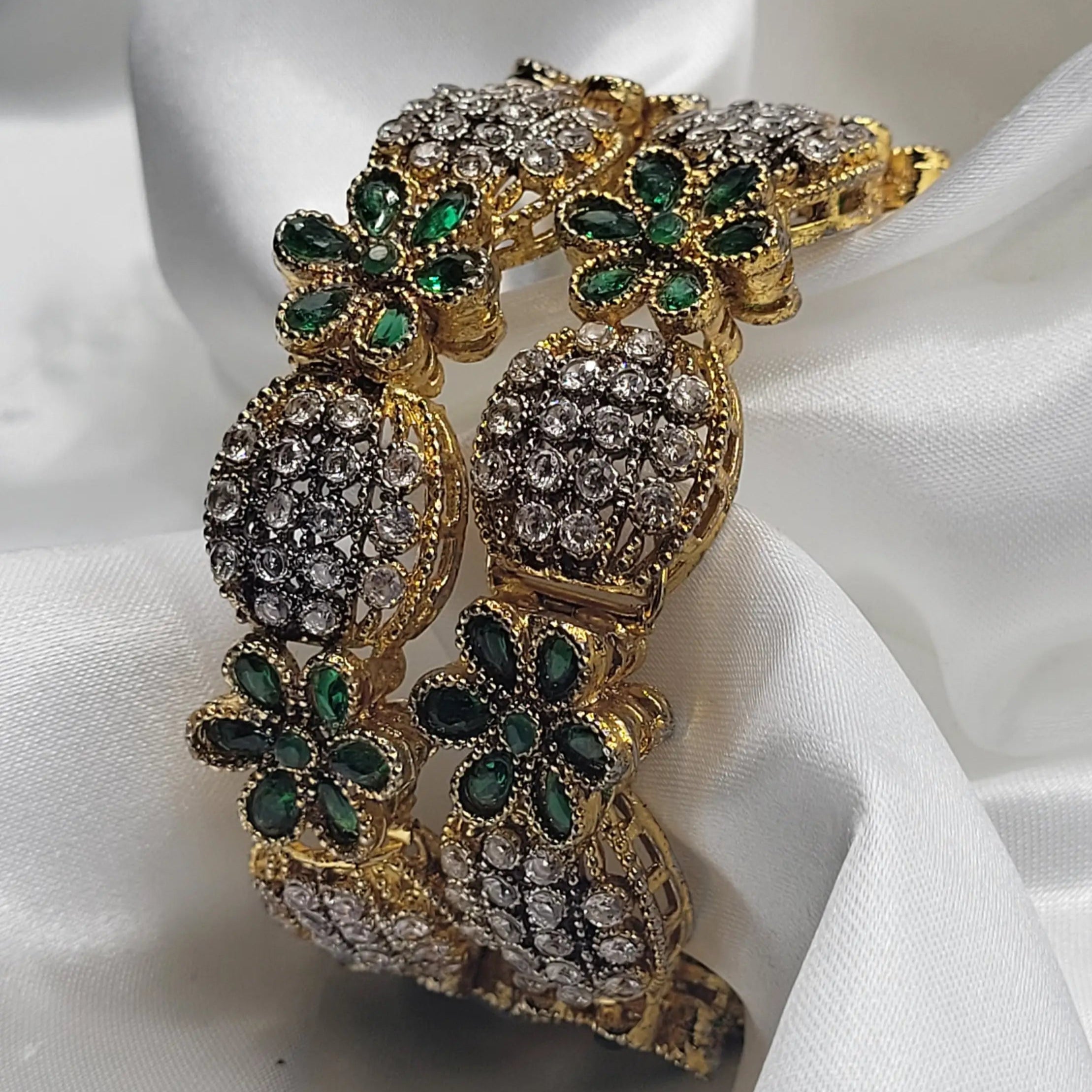 Green floral crystal bangles with intricate design and clear gemstones on a white fabric background – JV3001 