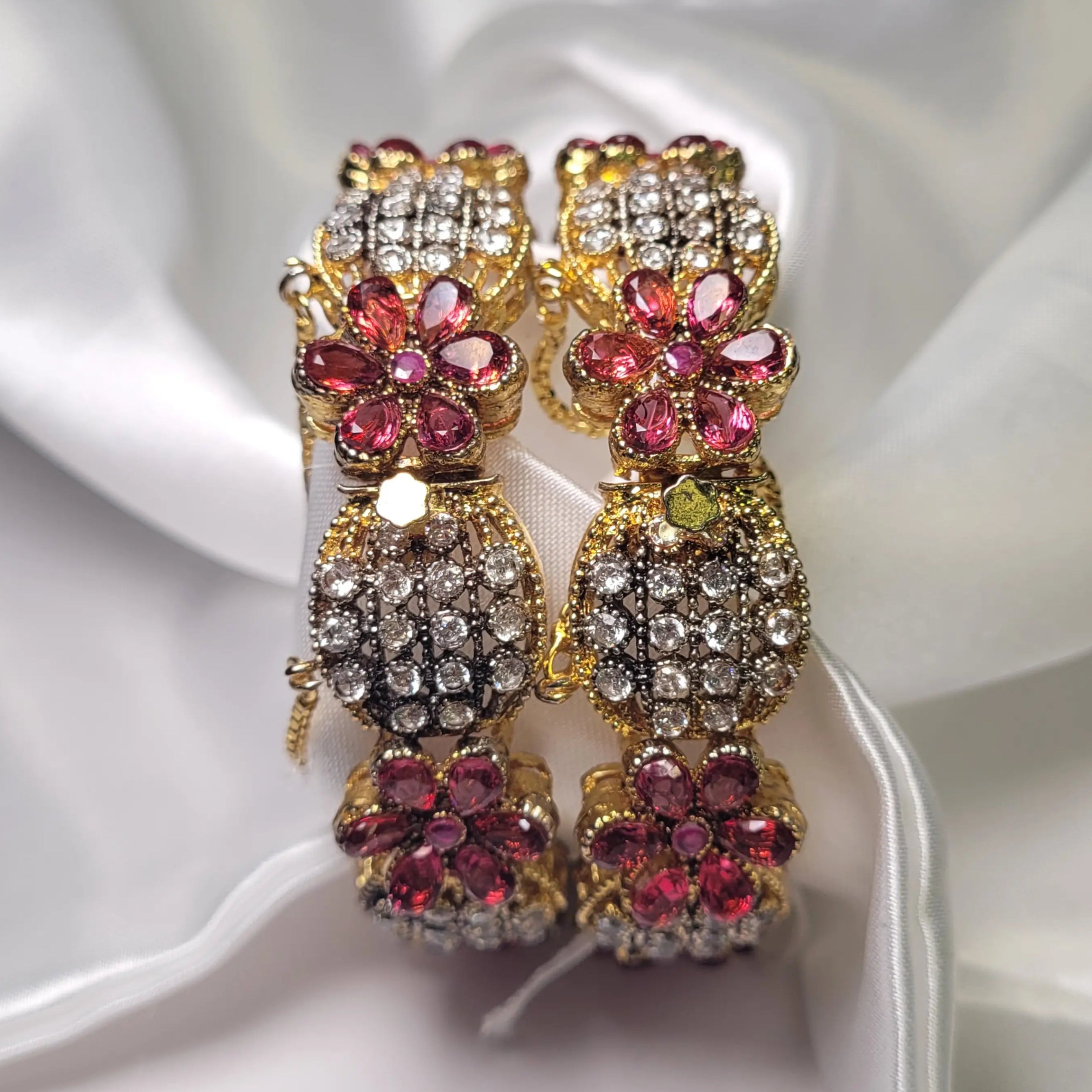 Pink floral design bangles with crystals on a white fabric background – JV3001 