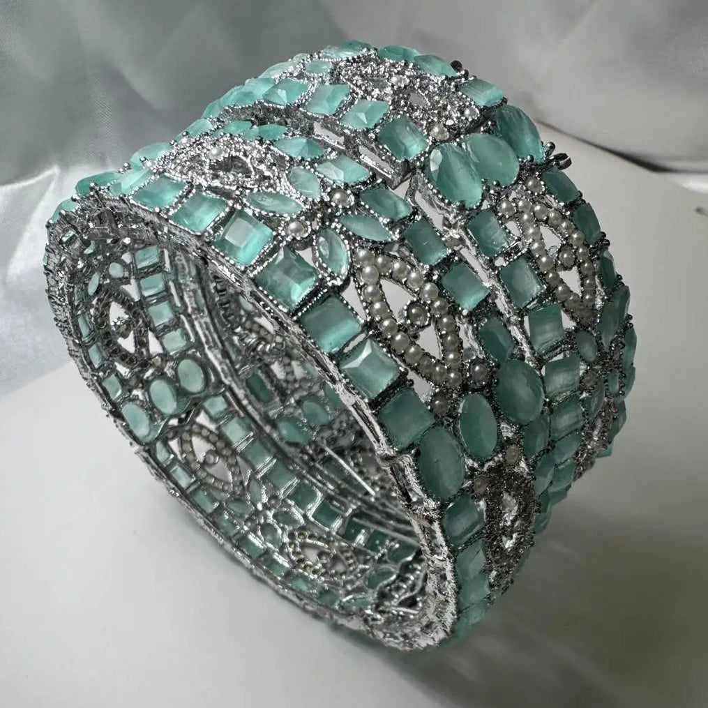 Silver-tone openable bangles with Turquoise and silver detailing on a white background