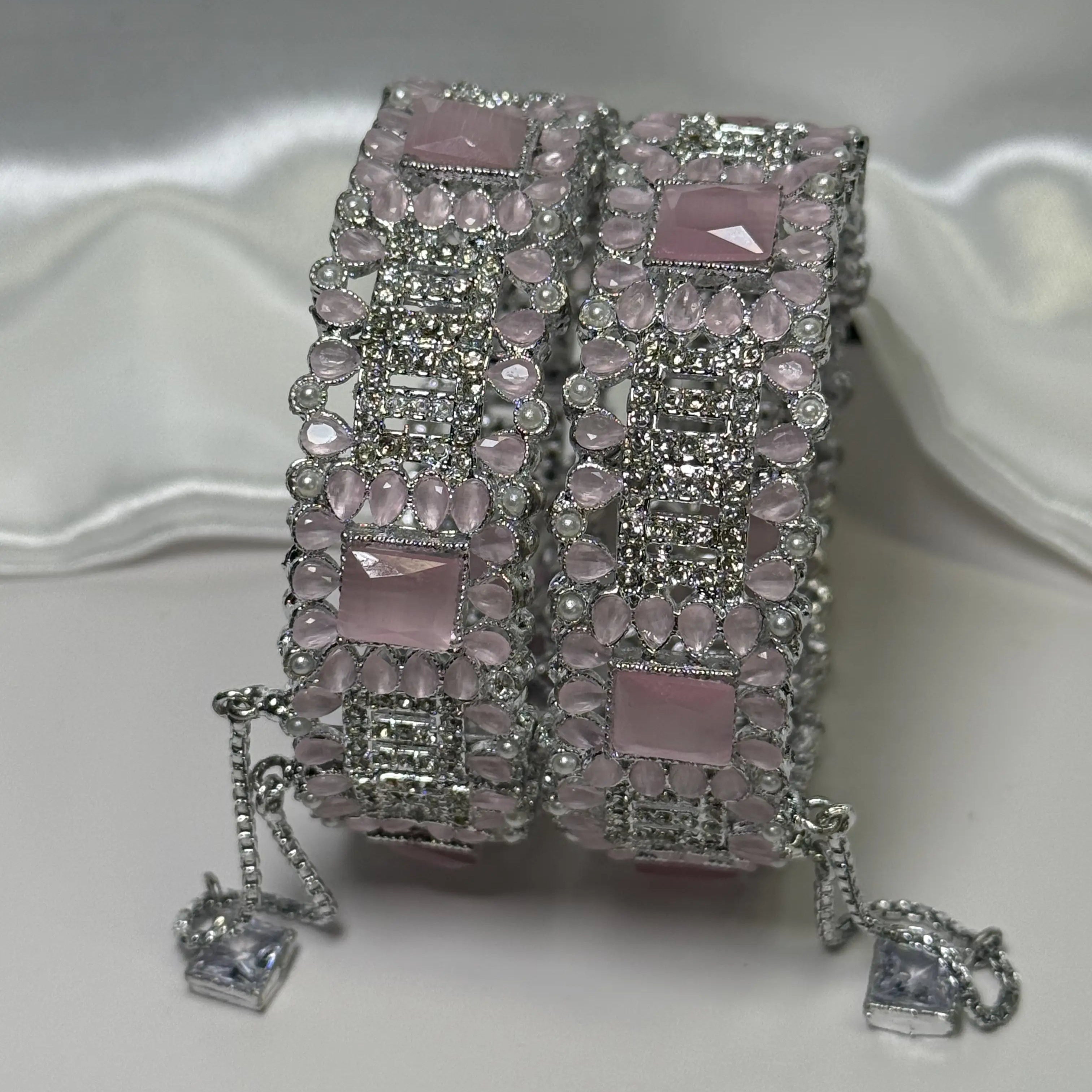 Elegant pink and silver bangles with secure clasp and charm