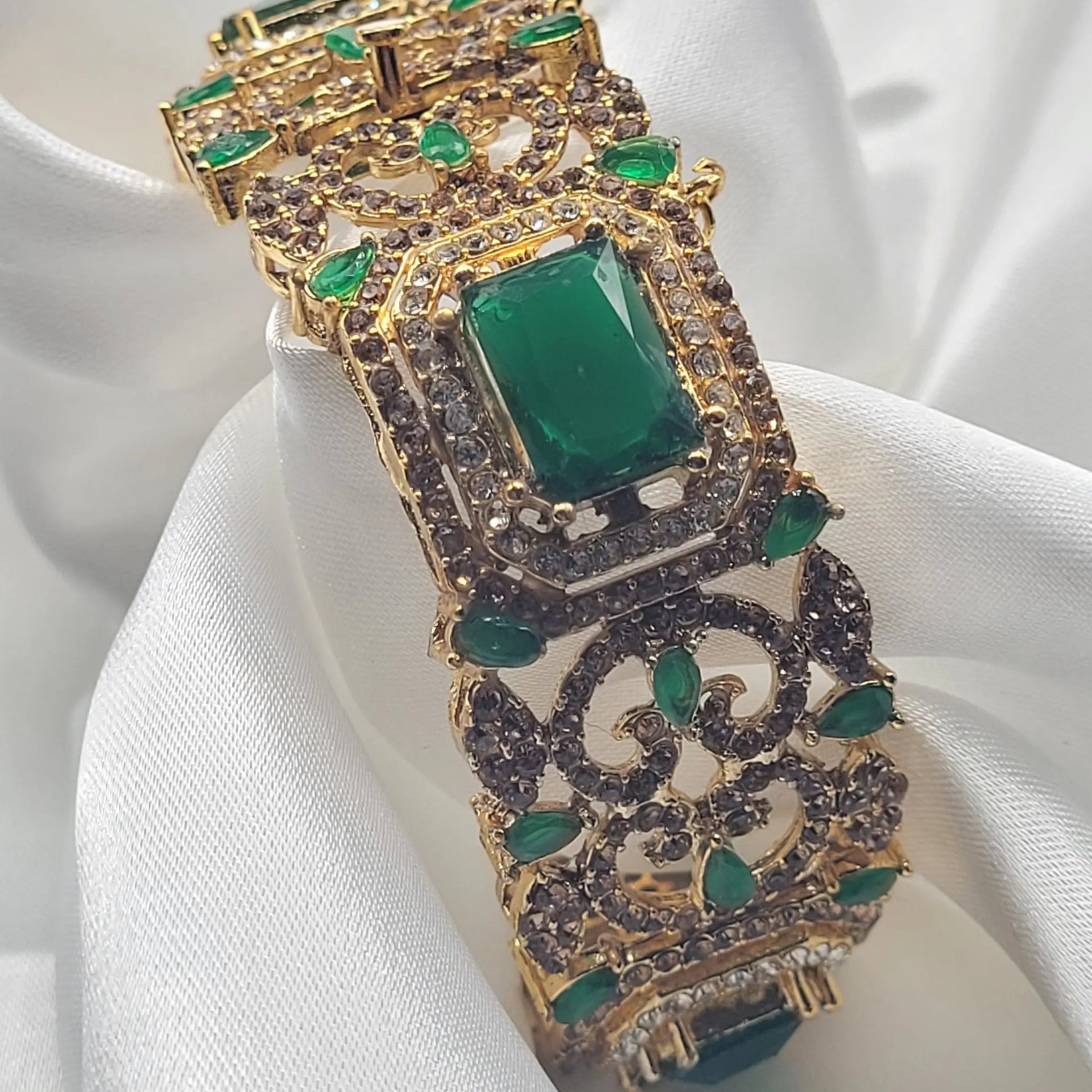 Green stone filigree bangle with gold-plated detailing – angled view