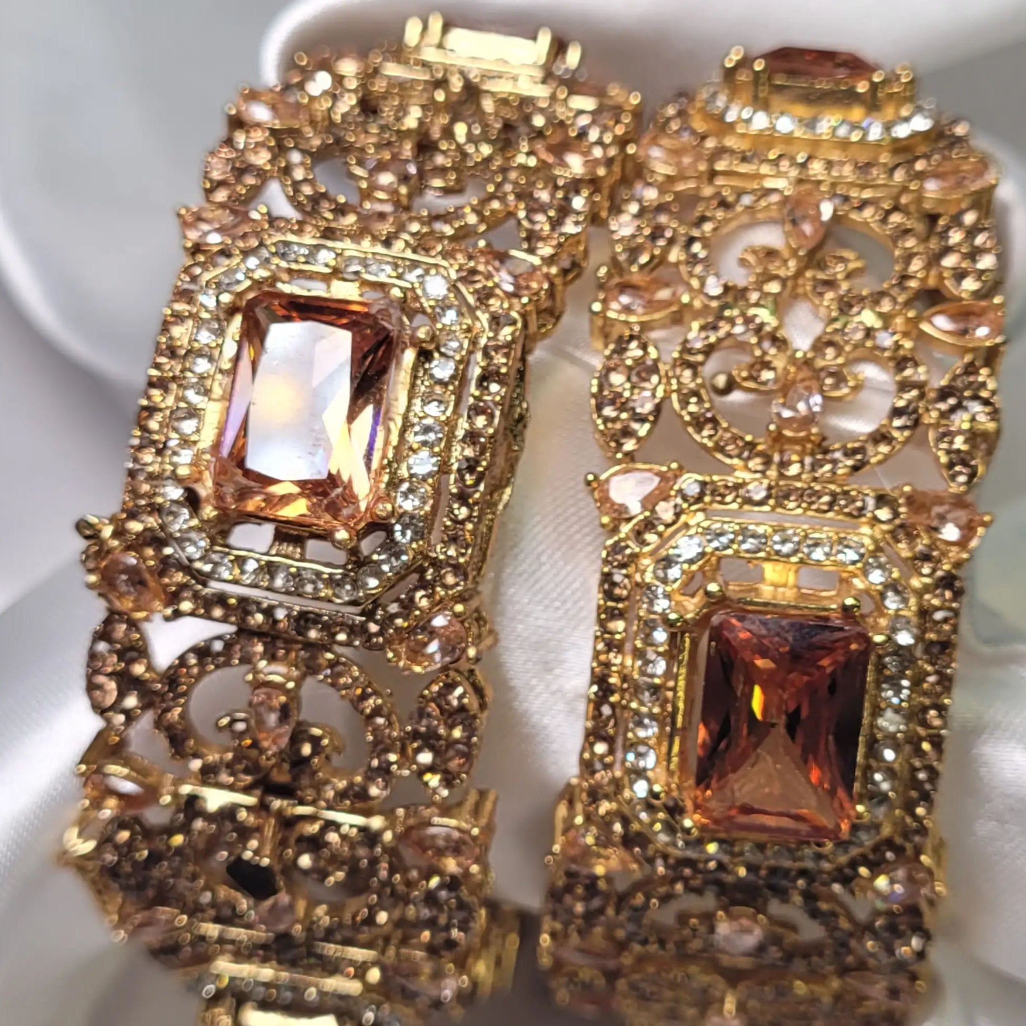 Close-up of champagne openable bangle with CZ accents and gold finish