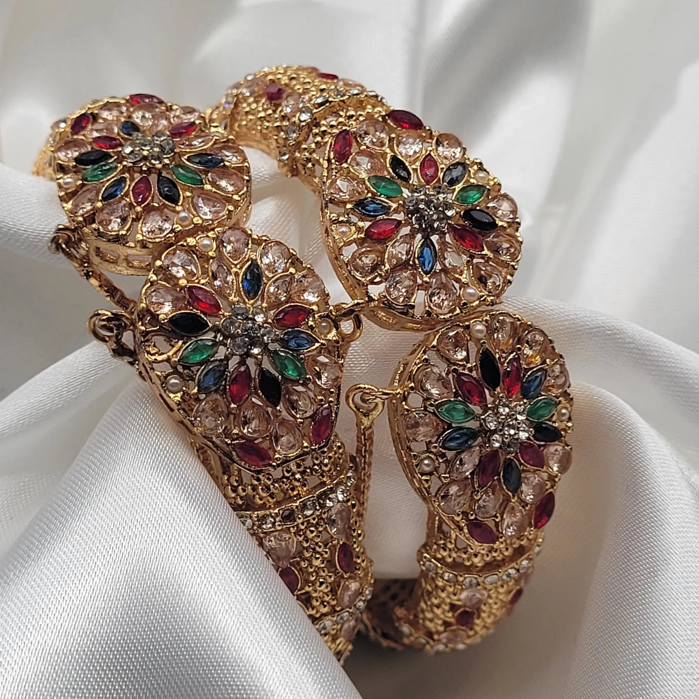 Openable bangles featuring red, green, and blue marquise stones – top view