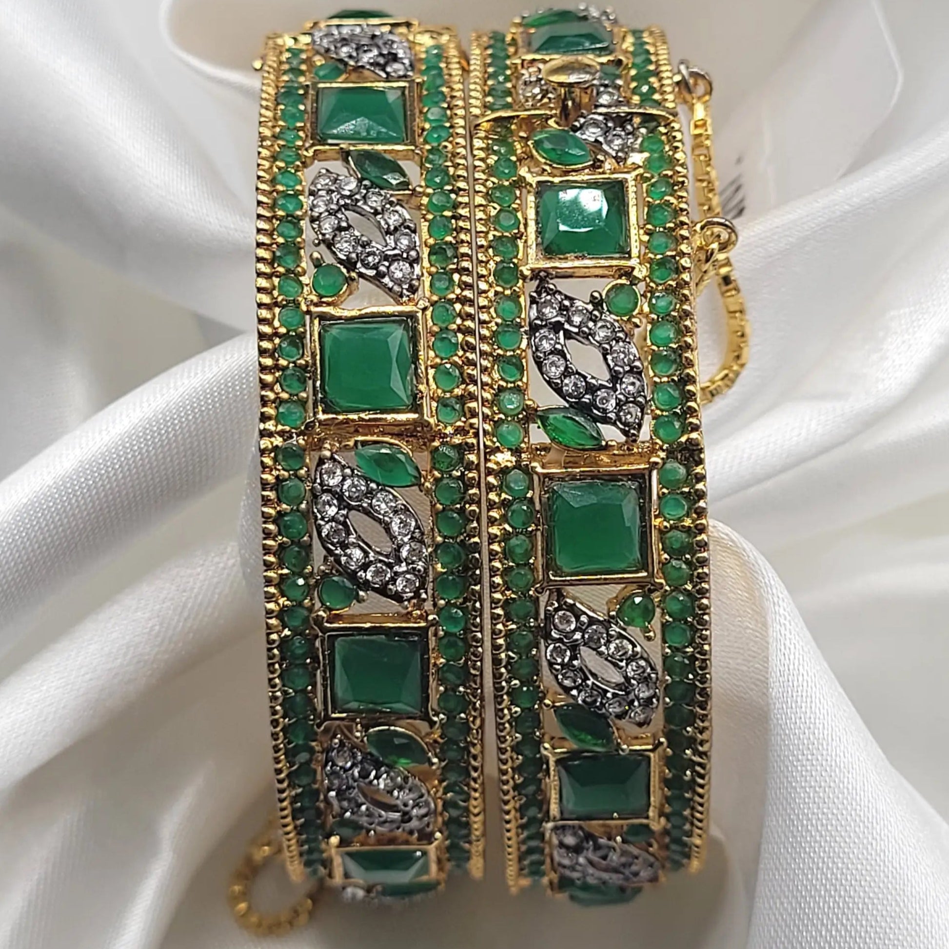 Gold bangles with emerald green stones for festive wear – front display