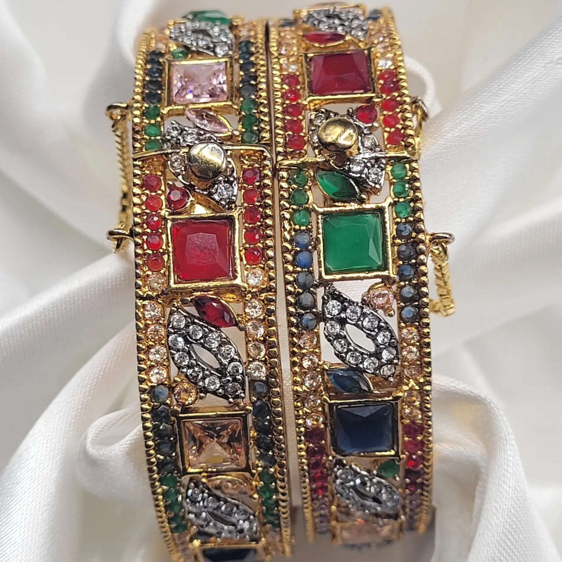 Gold bangles with colorful stones and antique detailing – close-up