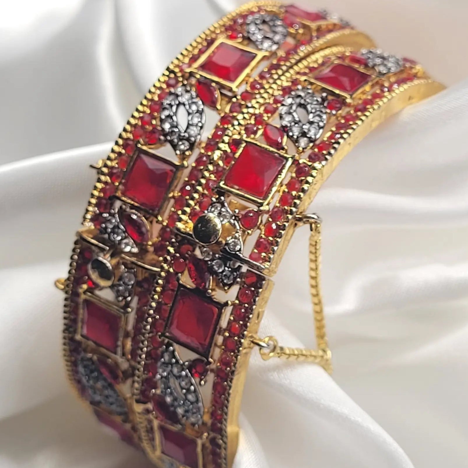 Bright red square-cut bangles with gold finish and floral accents – side