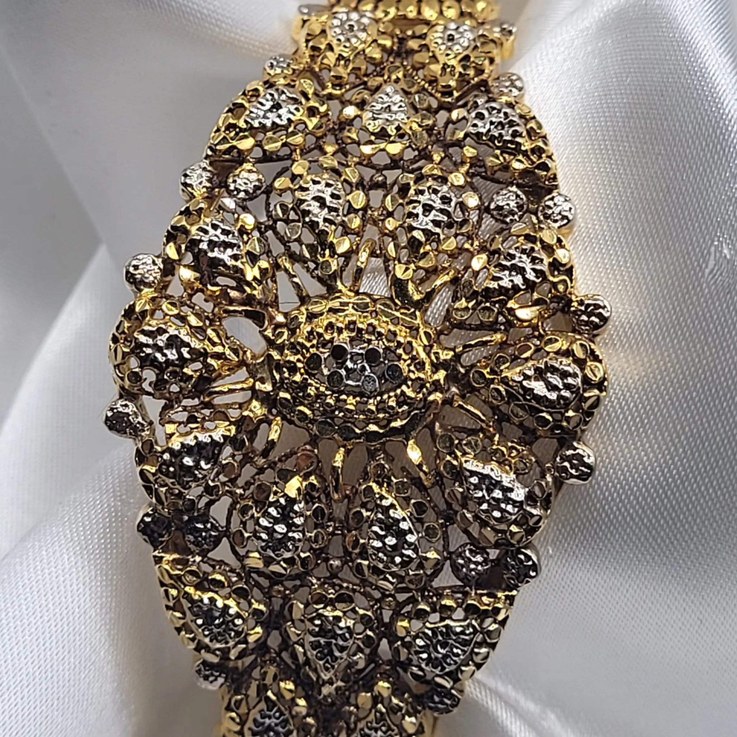 Detailed close-up of openable gold and oxidized silver bangle