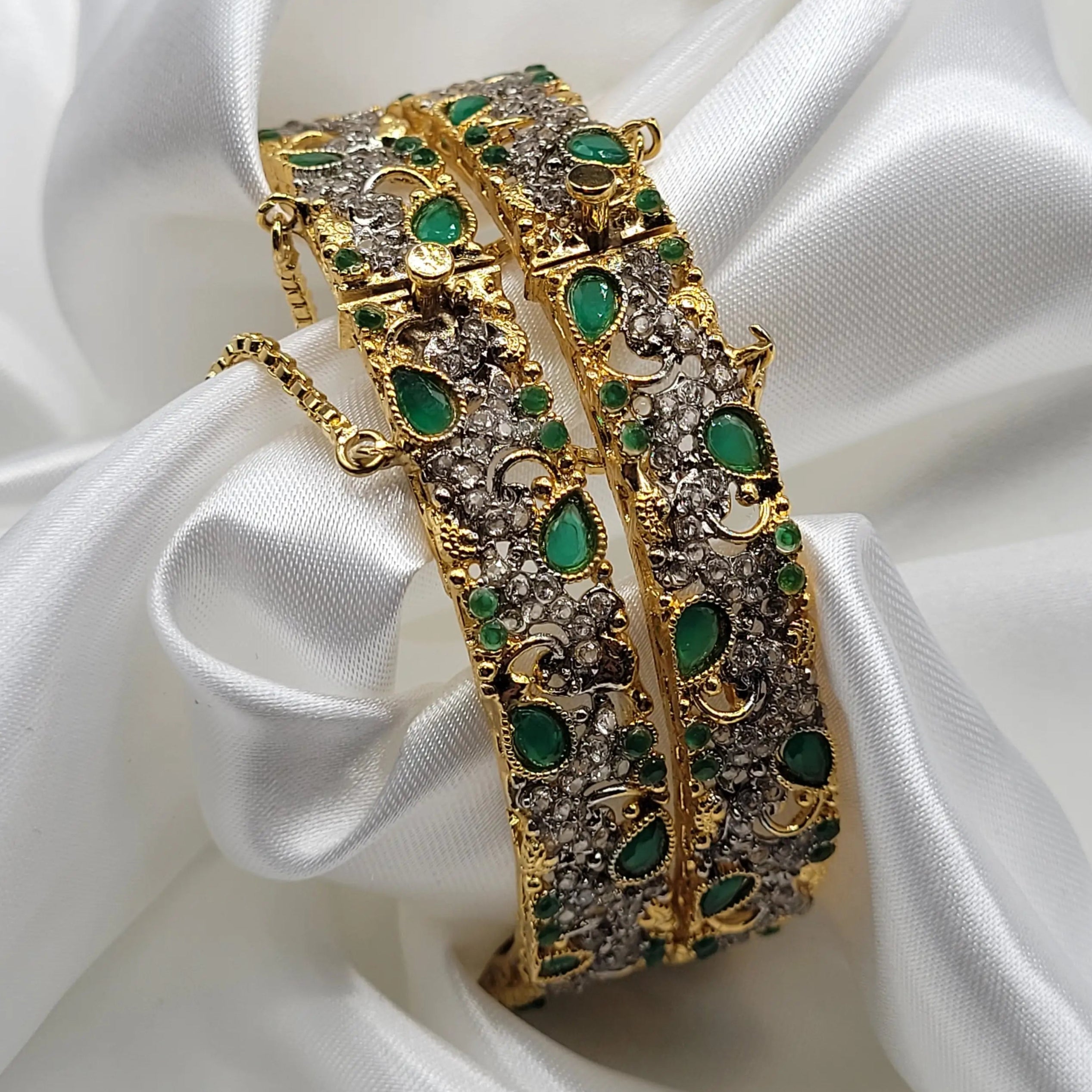 Openable green and gold bangles with crescent accents – angled shot