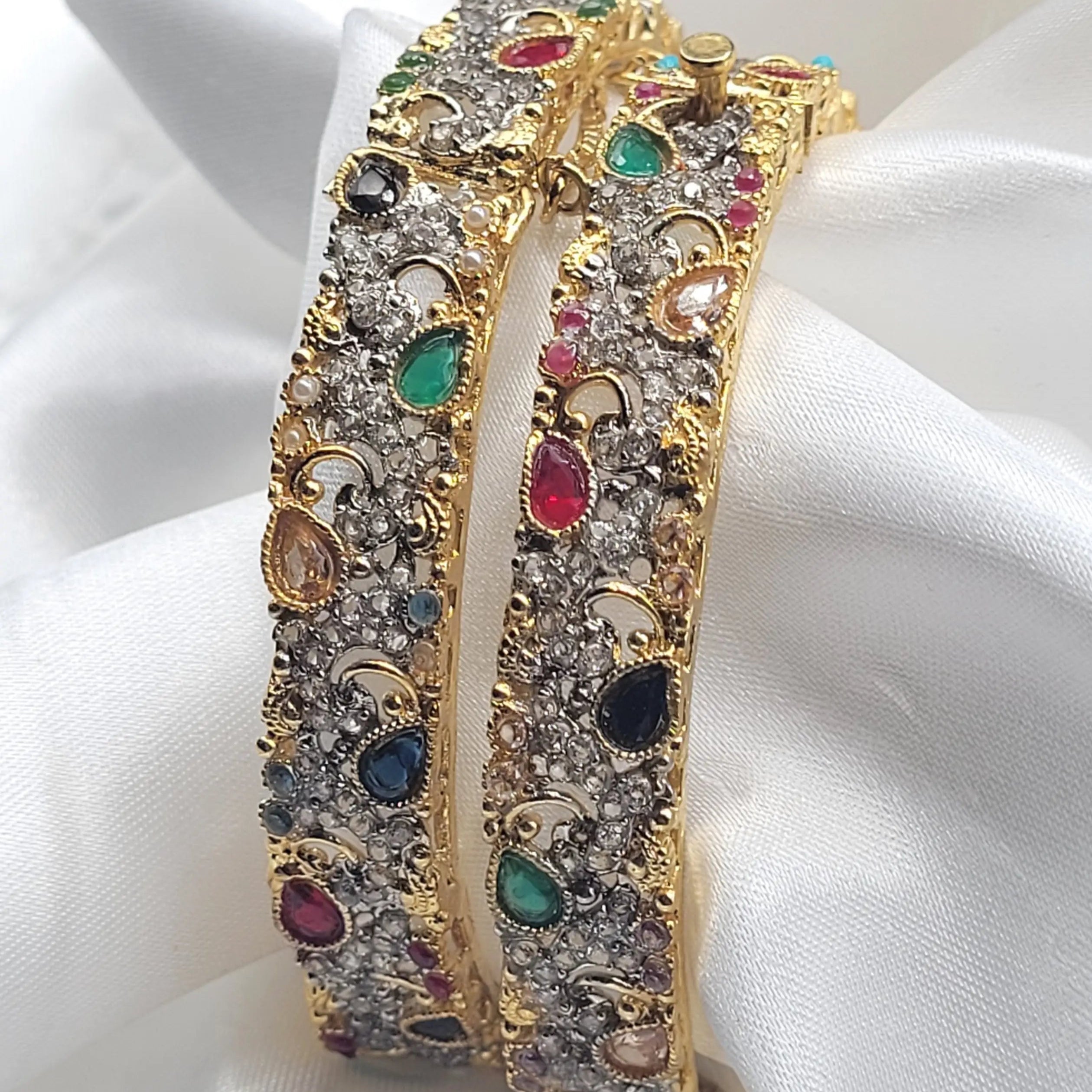 Side view of JV3018 bangles with emerald, ruby, and sapphire stones in antique finish