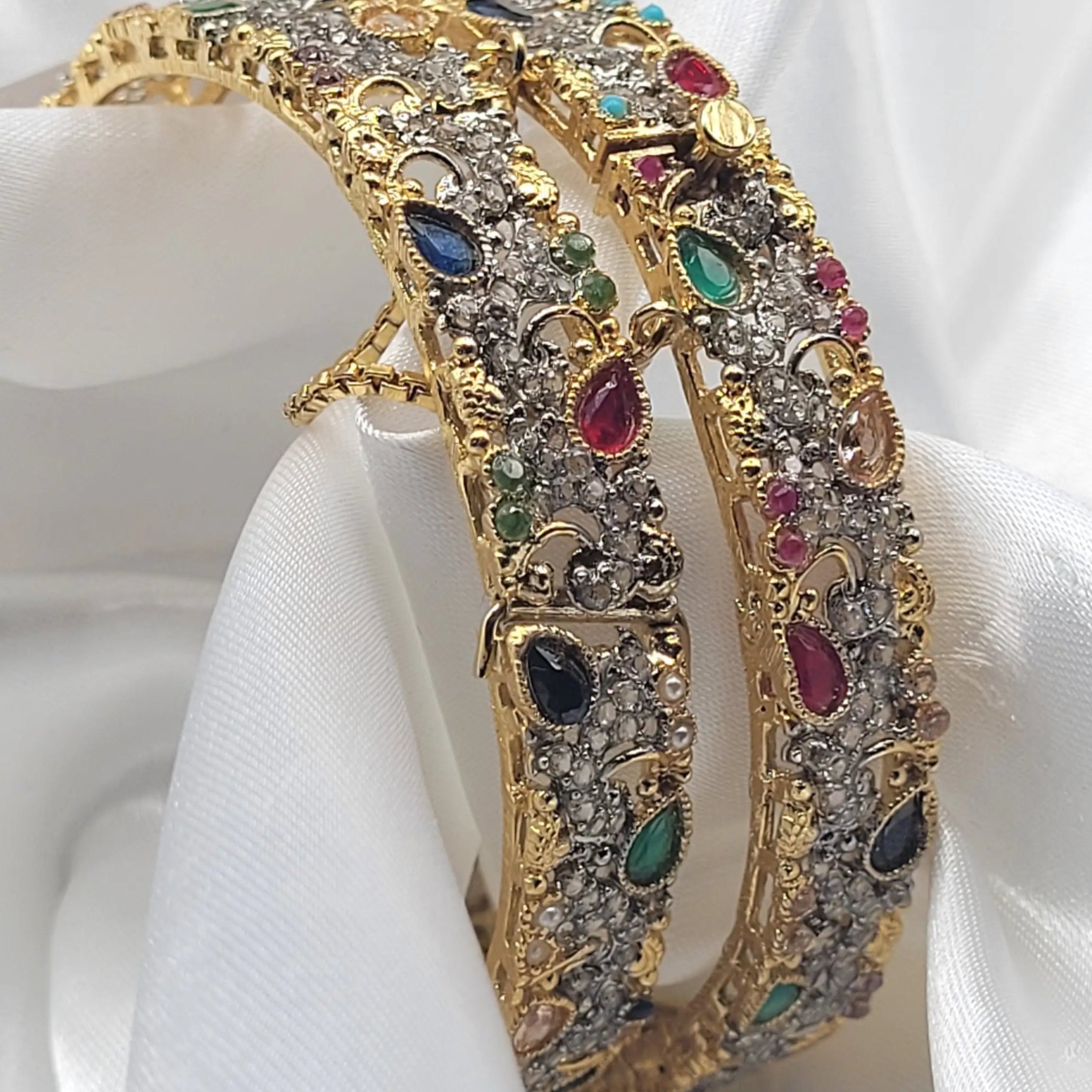 Angle view of JV3018 antique gold bangles with crescent moon motifs and colorful stones