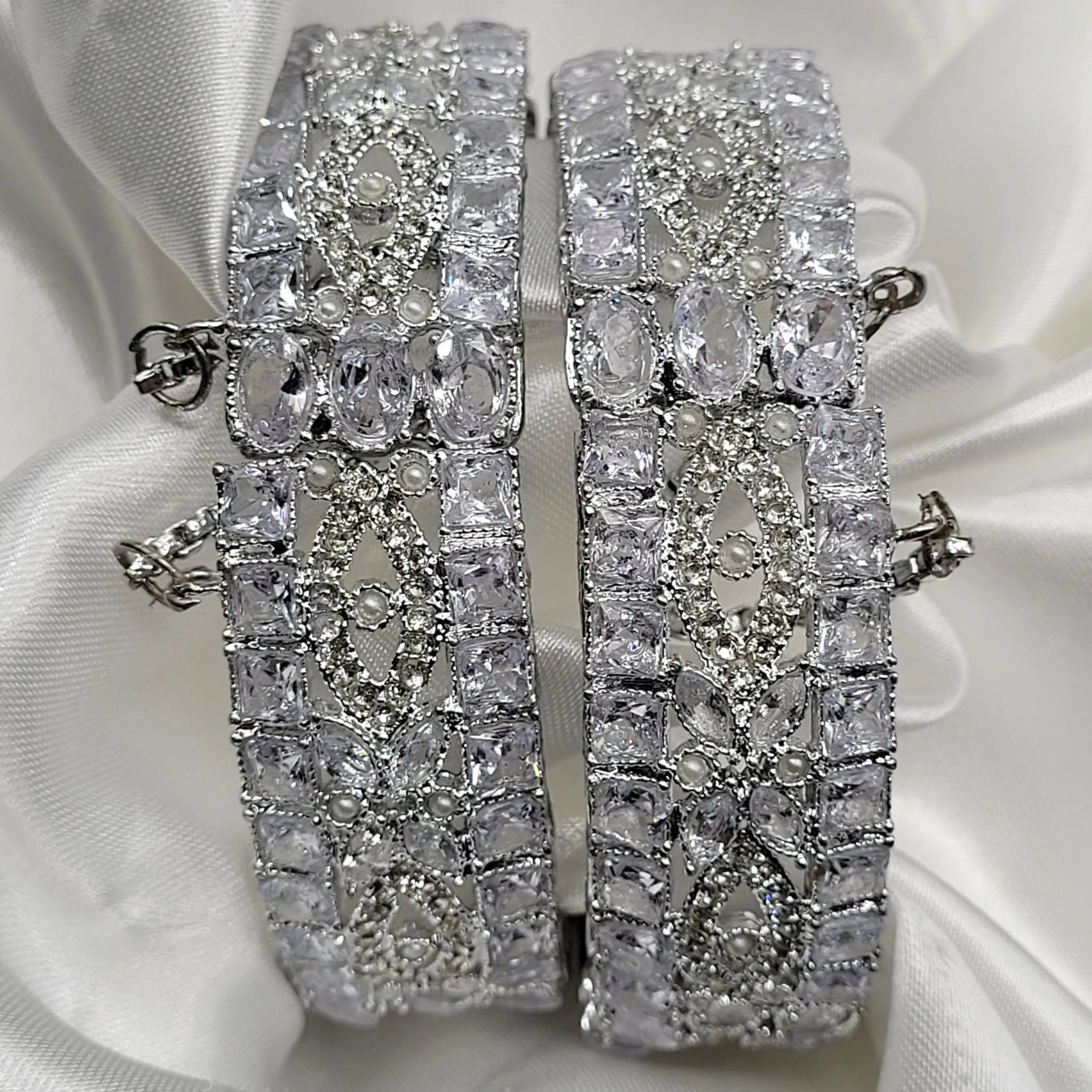 Pair of silver bangles with clear square and teardrop stones – top view