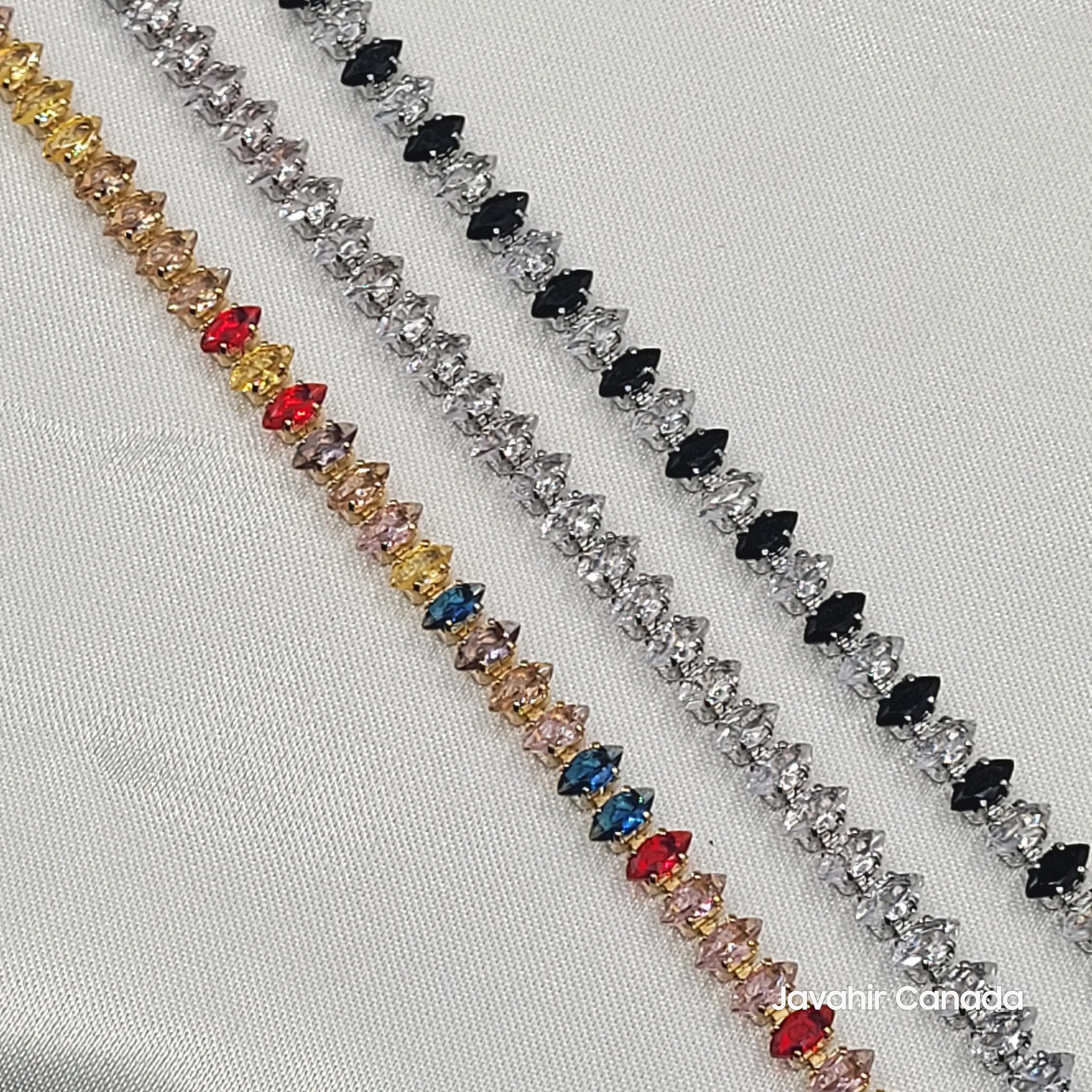 Close-up of marquise stone bracelets with silver and gold finish