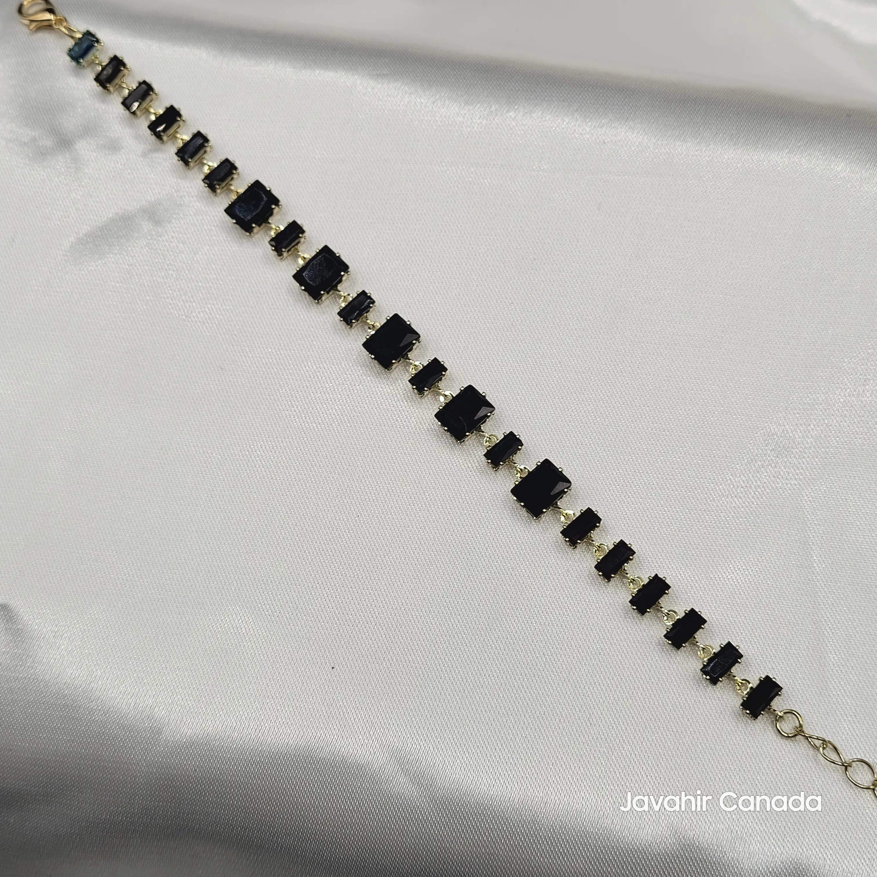 JV4007 bracelet with bold black emerald-cut stones set in gold-tone metal