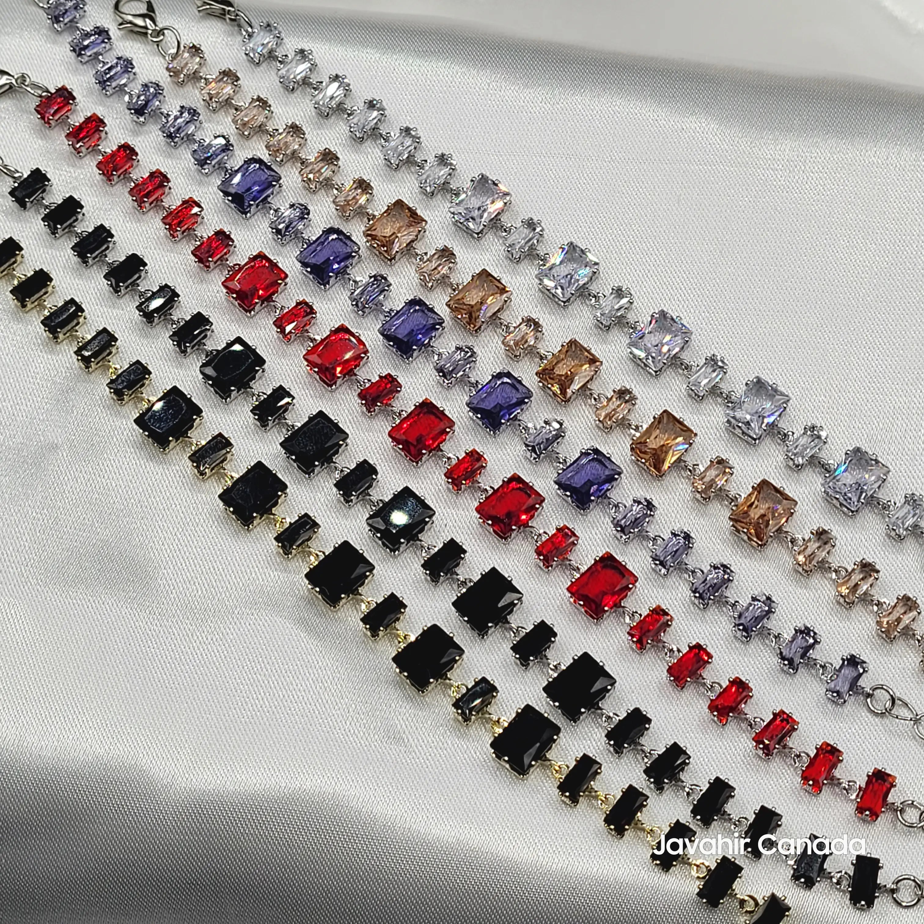 Flat lay of JV4007 bracelet collection with emerald-cut stones in assorted colors and finishes
