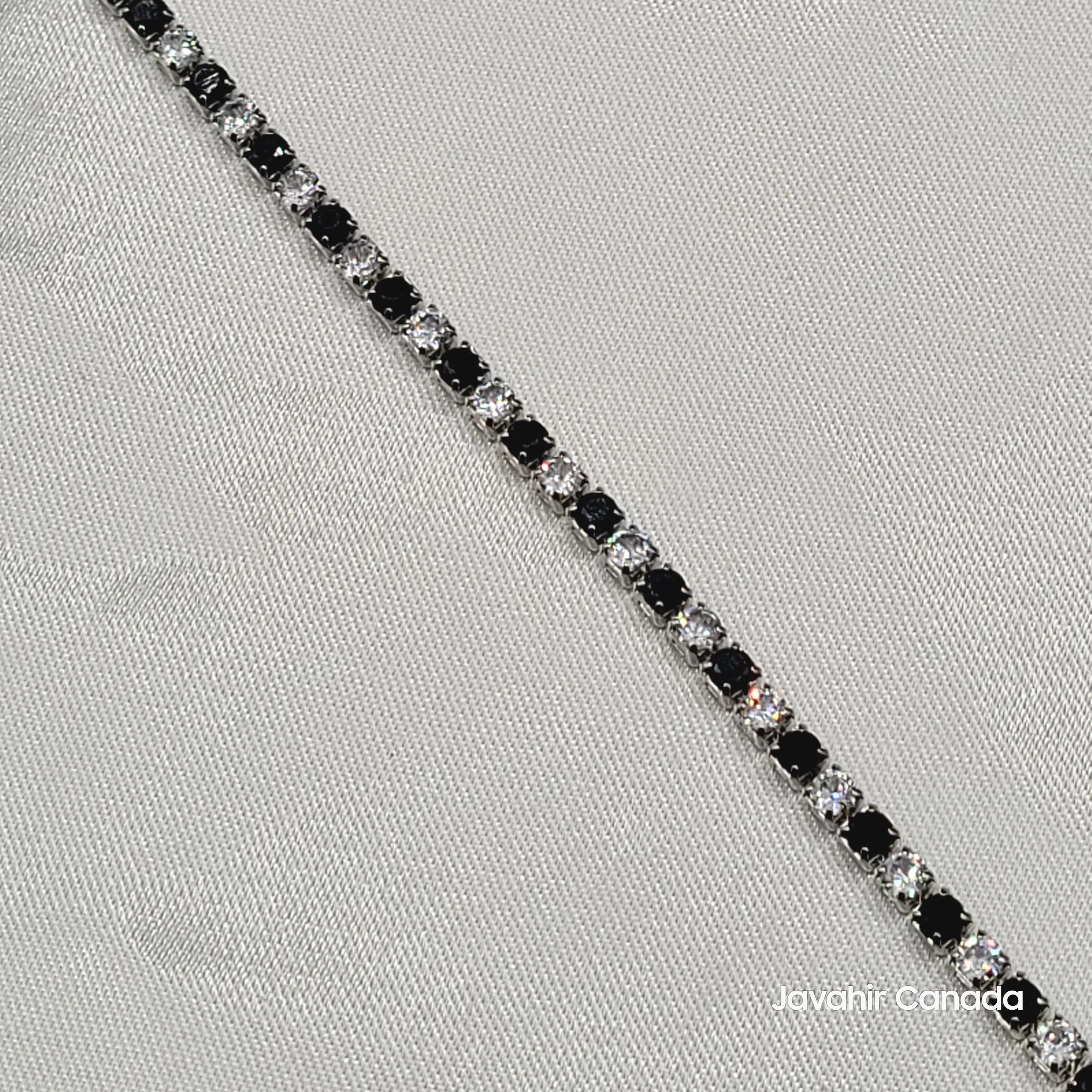 Close-up of round-cut black and white stones in silver-tone setting – JV4008