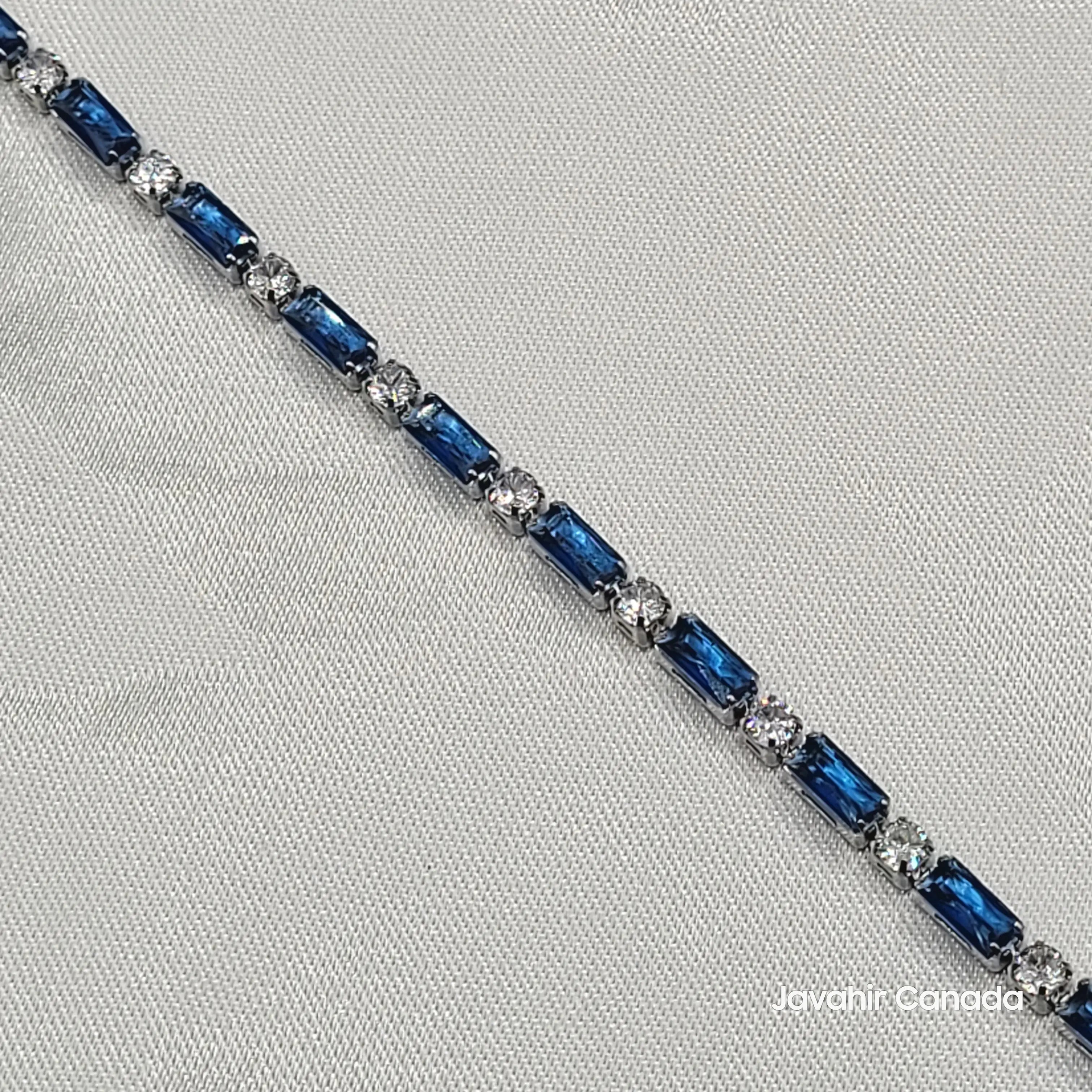 Close-up of JV4009 blue baguette-cut and clear CZ stone bracelet in polished silver finish