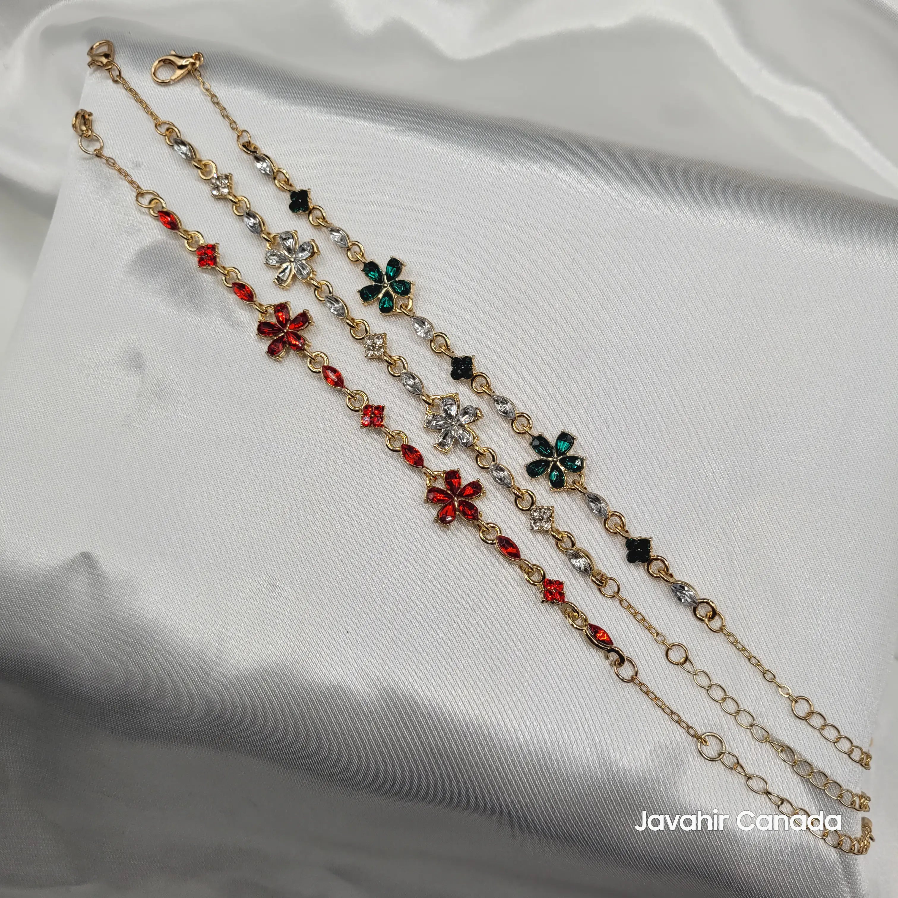 Three JV4012 floral gemstone bracelets in red, emerald green, and white – gold chain detail