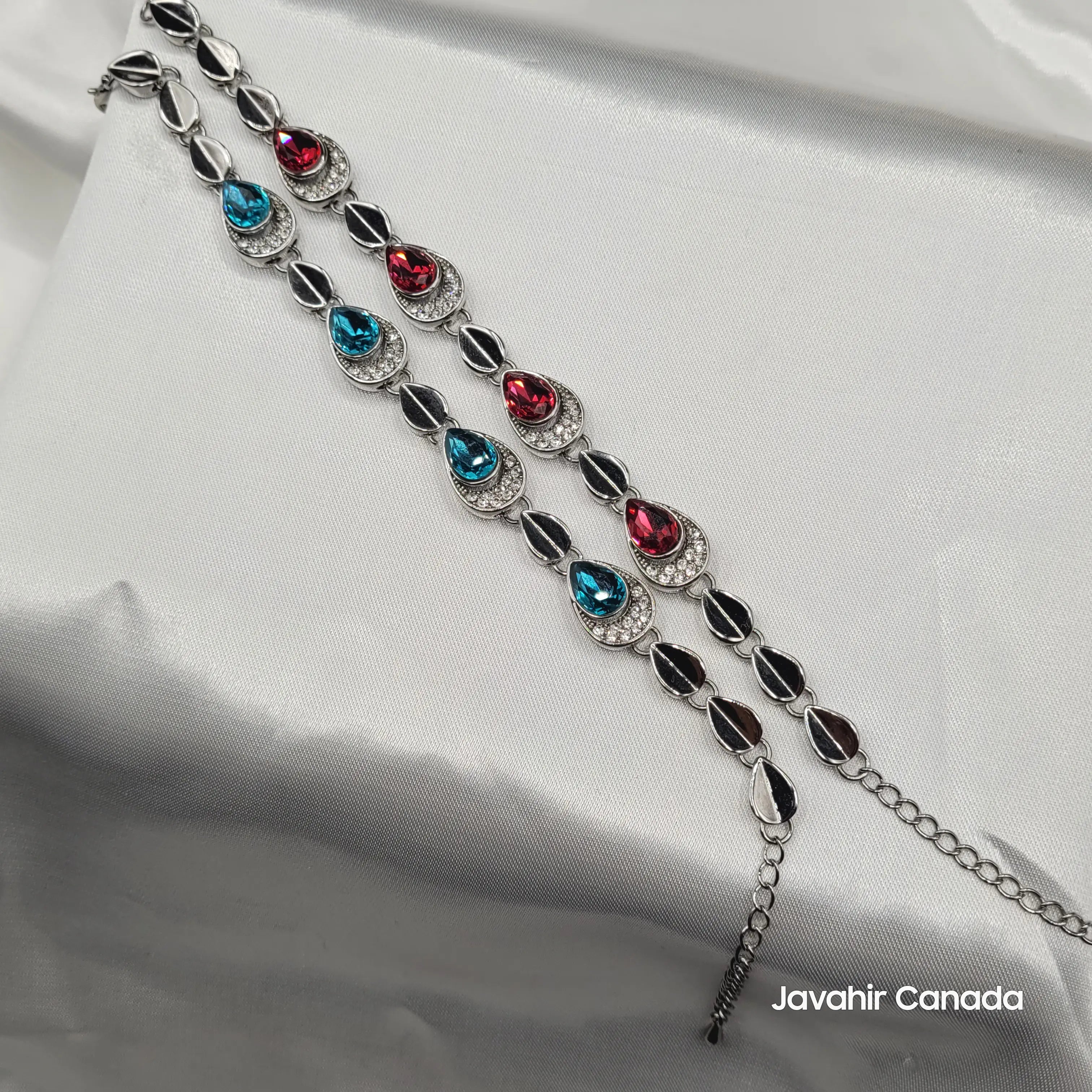 Full view of JV4015 silver bracelets with alternating teardrop CZ stones in pink and blue variants