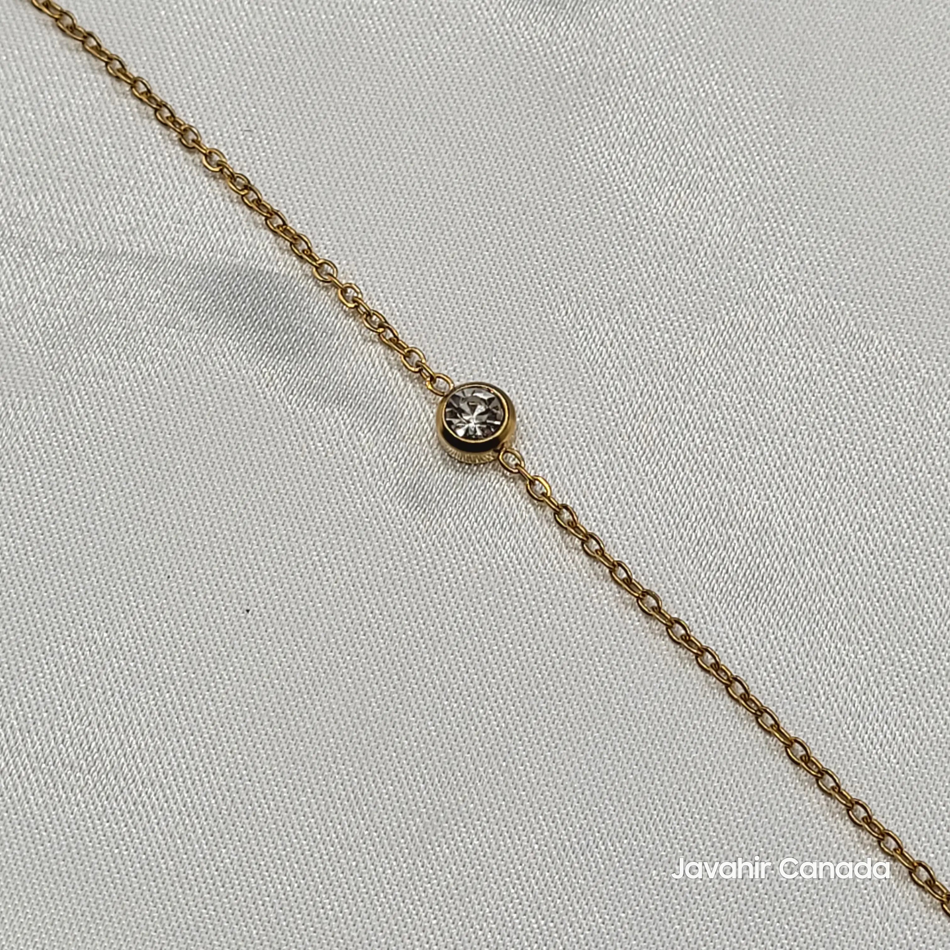 Close-up of JV4021 bracelet showing bezel-set round American diamond on gold chain