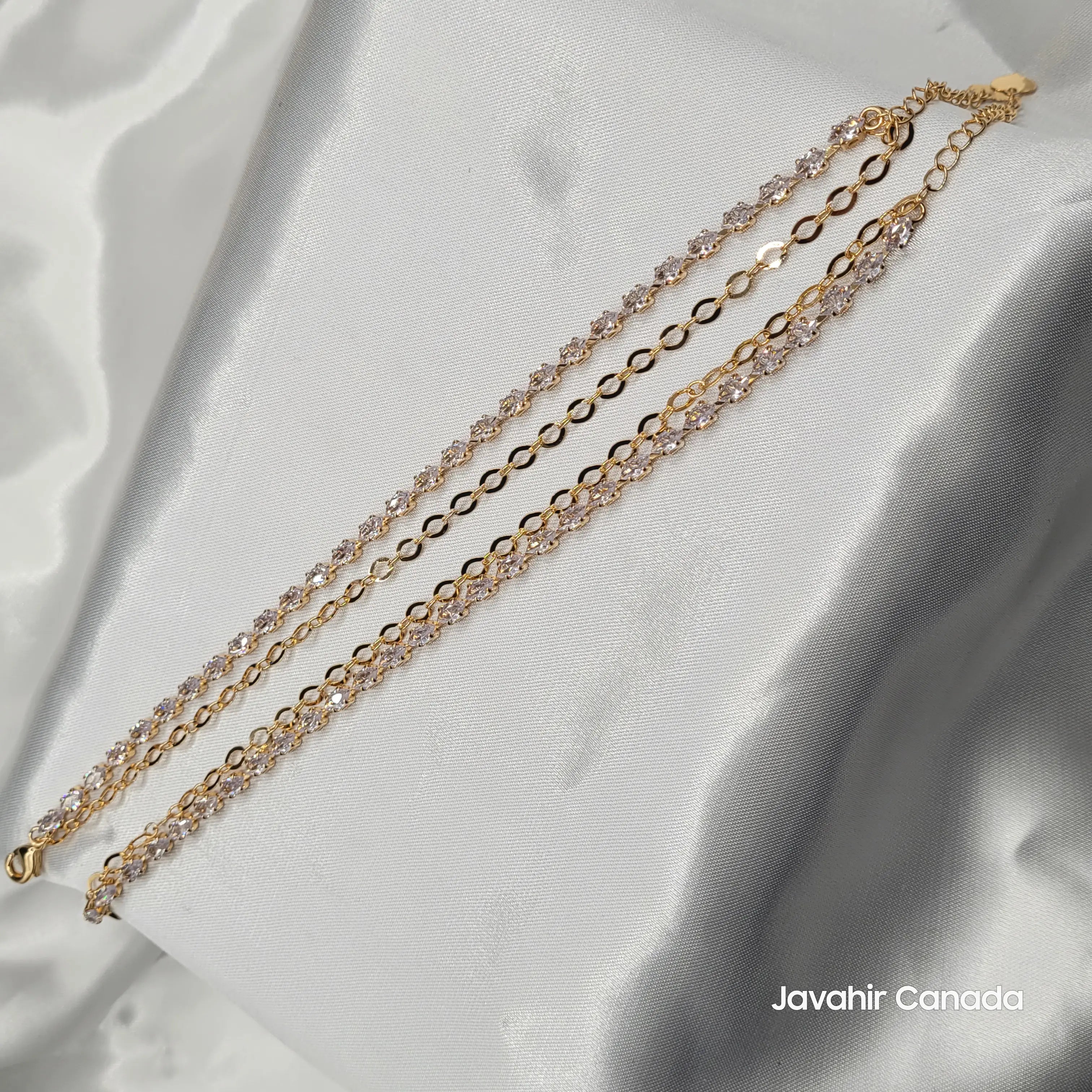 JV5009 gold plated anklet pair with clear round stones on satin fabric