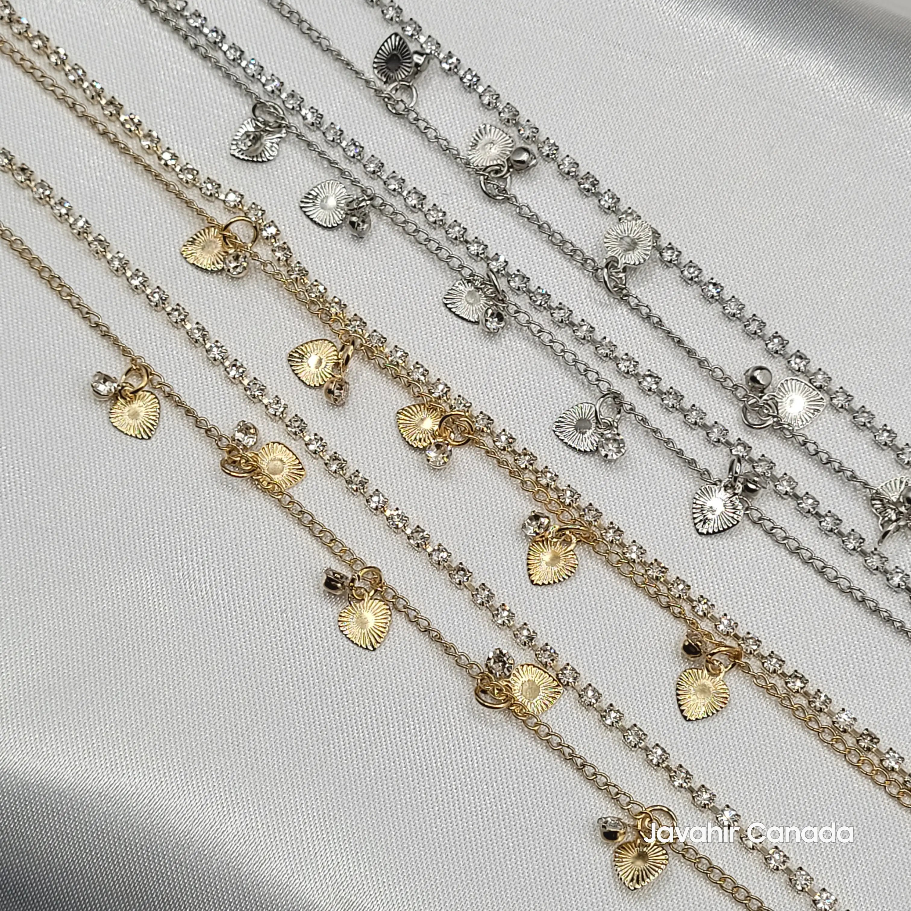 Close-up of JV5010 anklets showing textured heart charms and crystal link design in both gold and silver variants