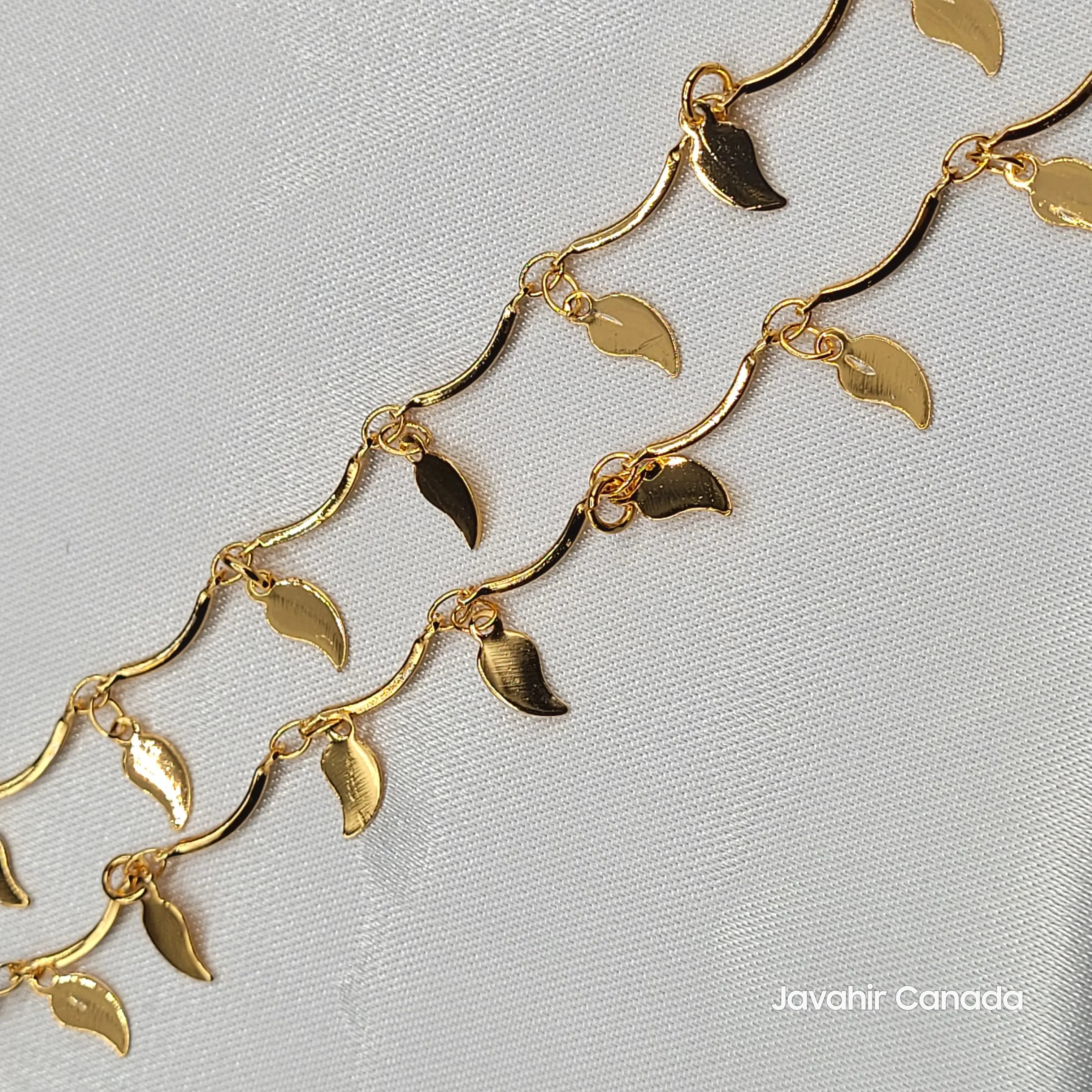 Close-up of JV5016 anklets featuring polished gold leaf charms on wavy chain design