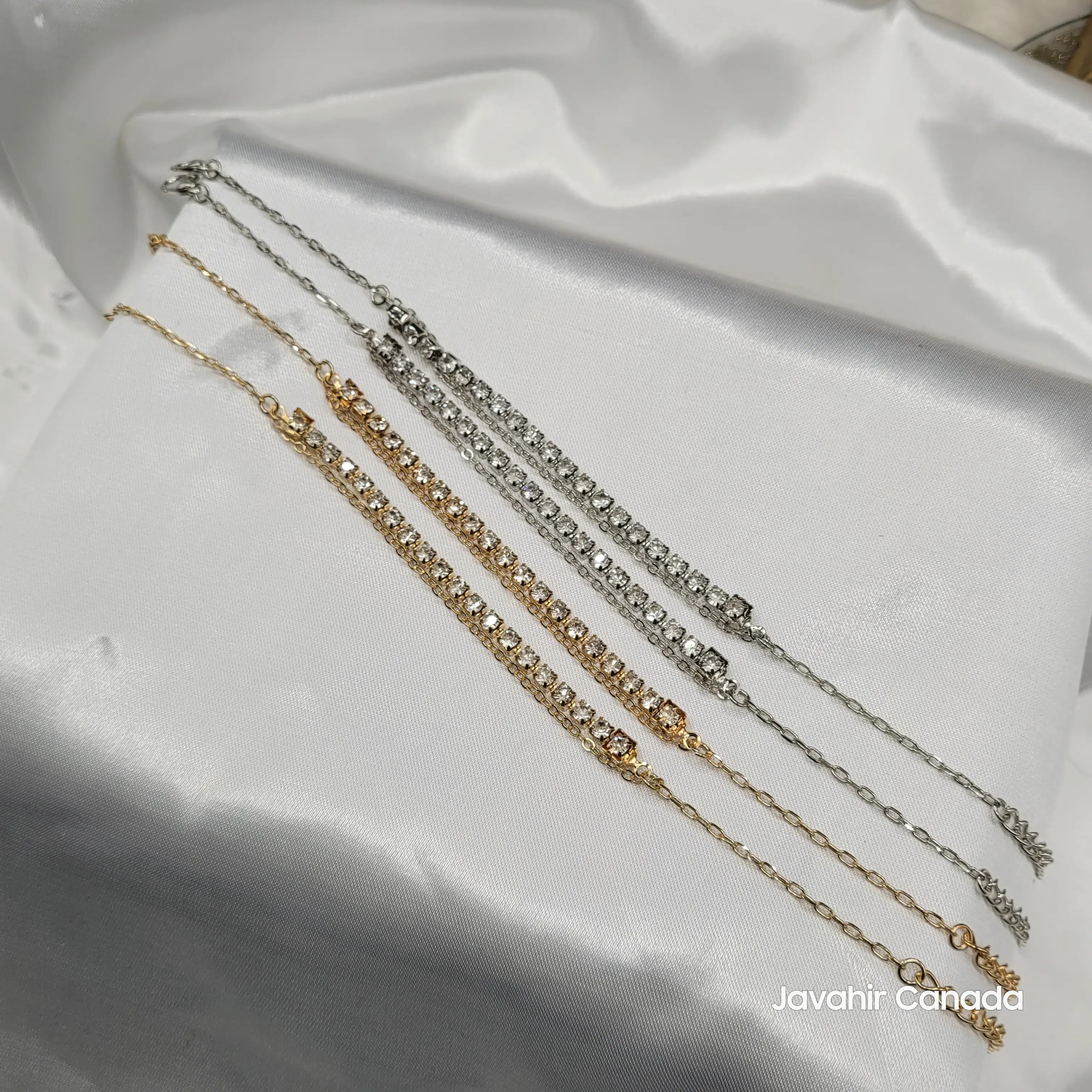 JV5022 gold and silver dual row anklets with American diamonds displayed on white satin