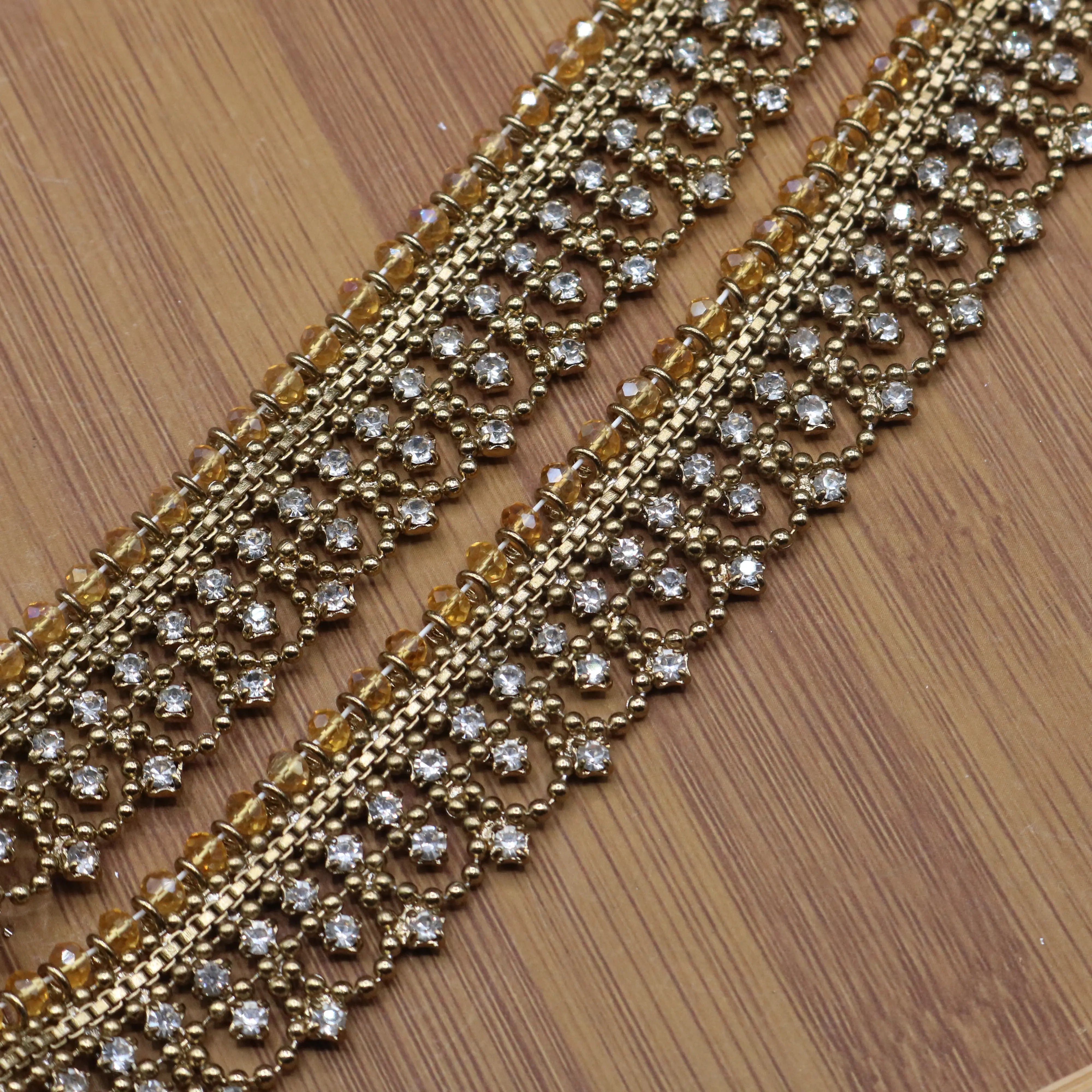 Angled view of ornate crystal and bead design on gold anklet pair – JV5024