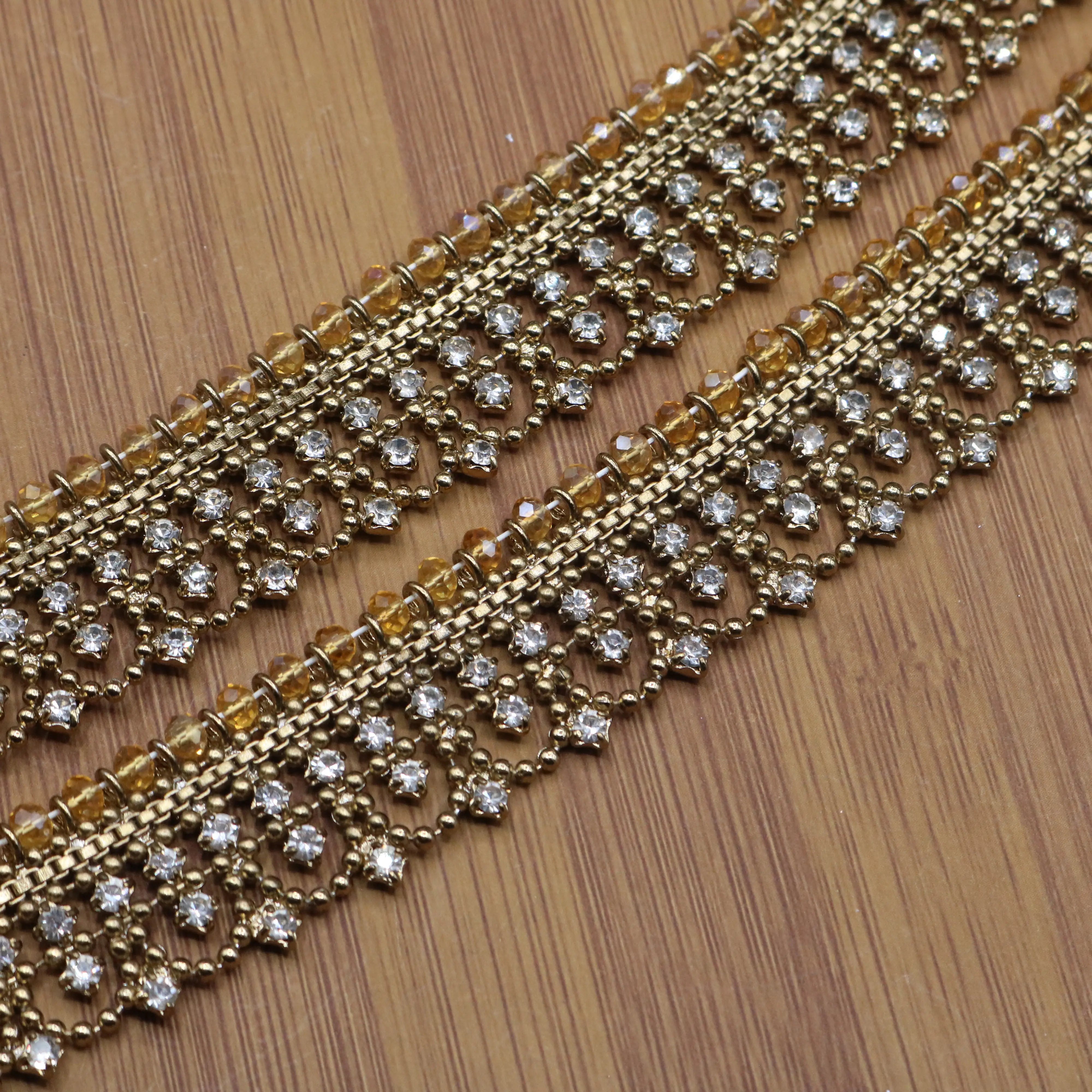 Close-up of gold plated anklets with white crystal stones and intricate beading – JV5024