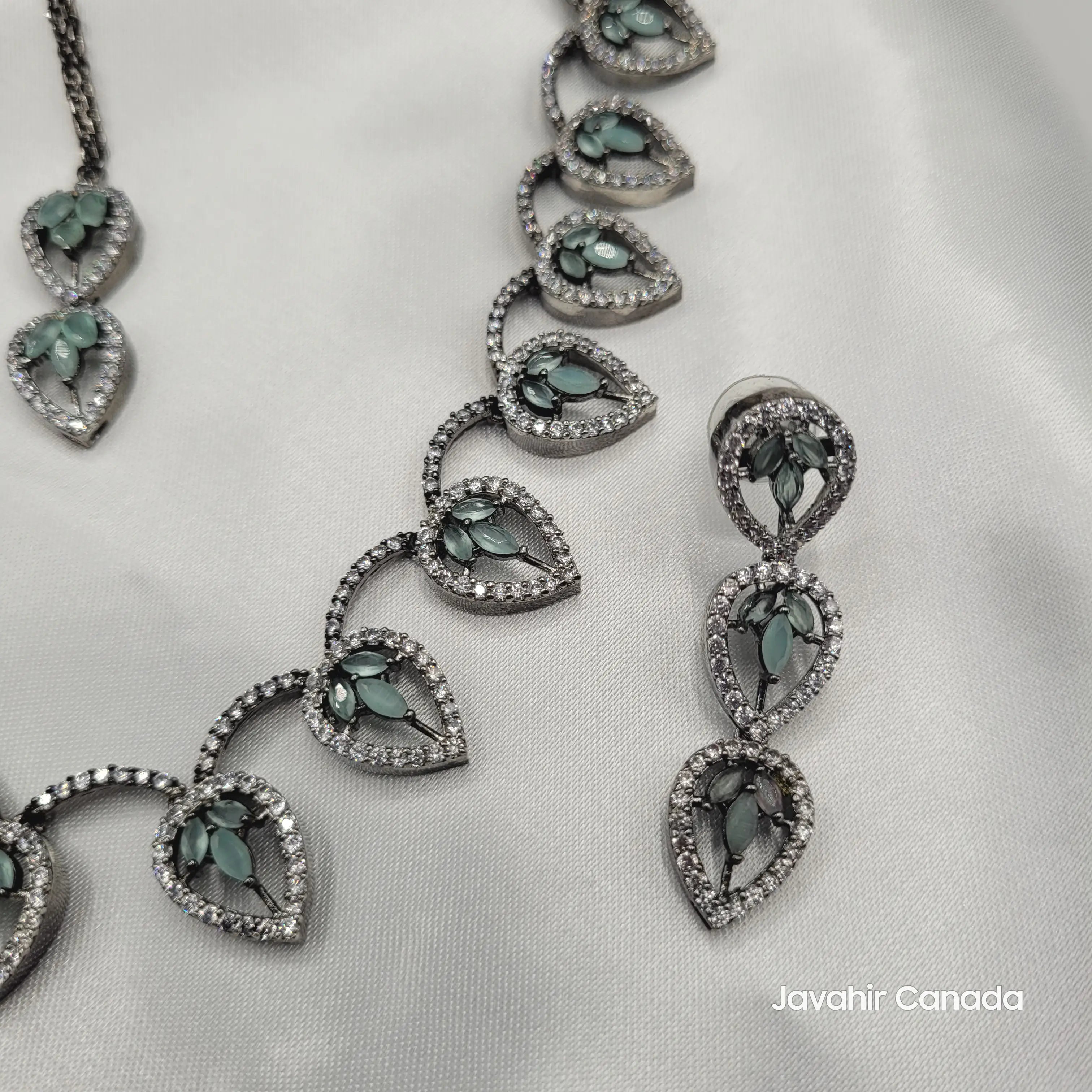 Earring close-up of JV08 with mint marquise leaf stones and diamond borders