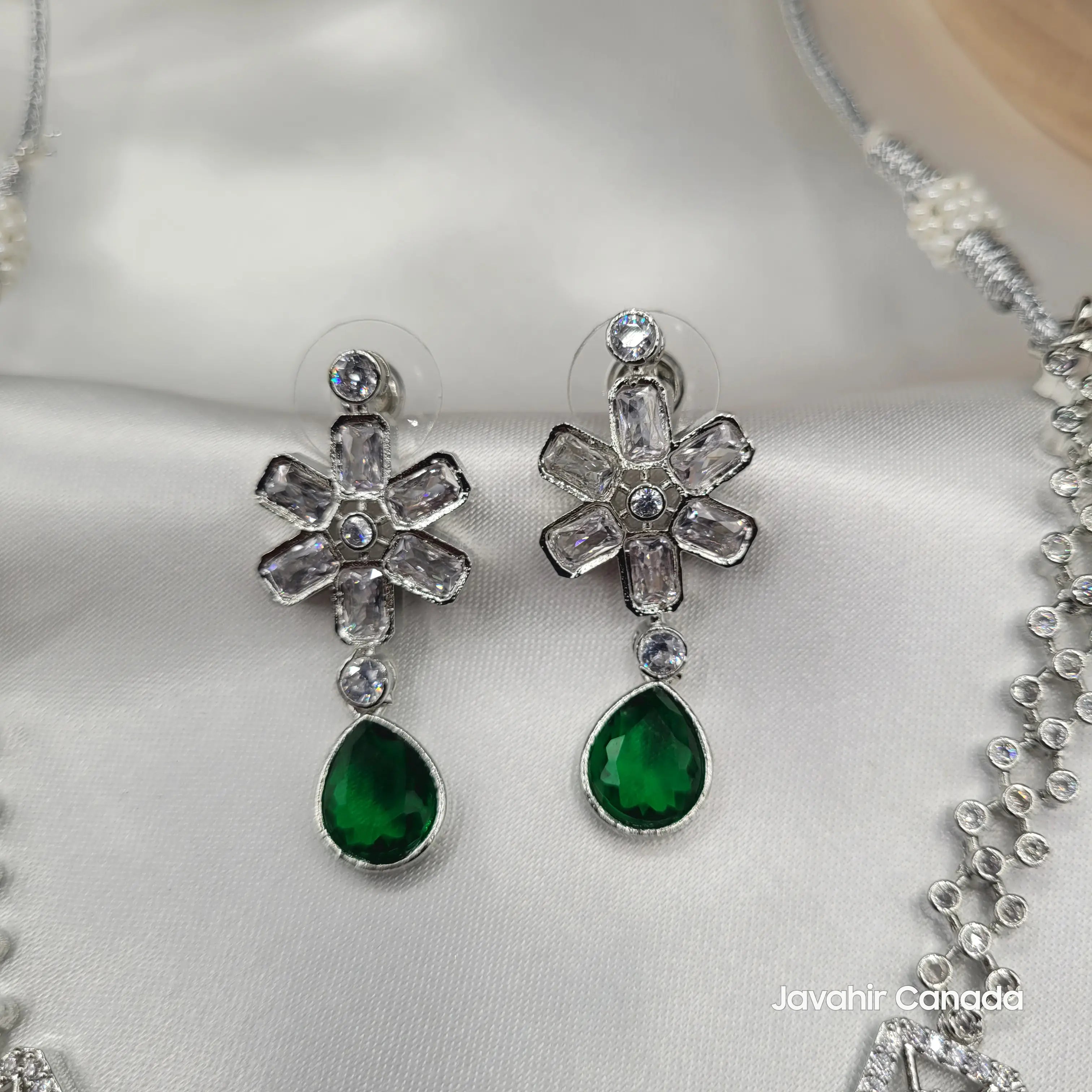 Close-up of emerald green variant with vibrant green pear-cut drops