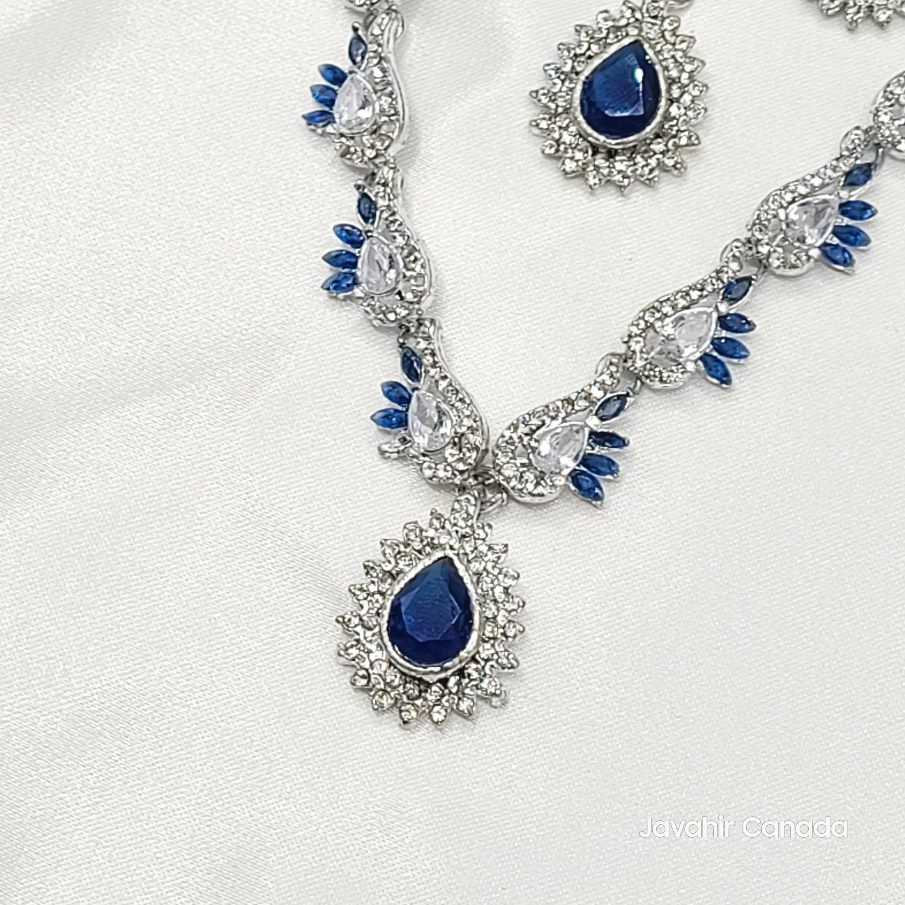 Elegant necklace with blue gemstones and silver accents on a white background