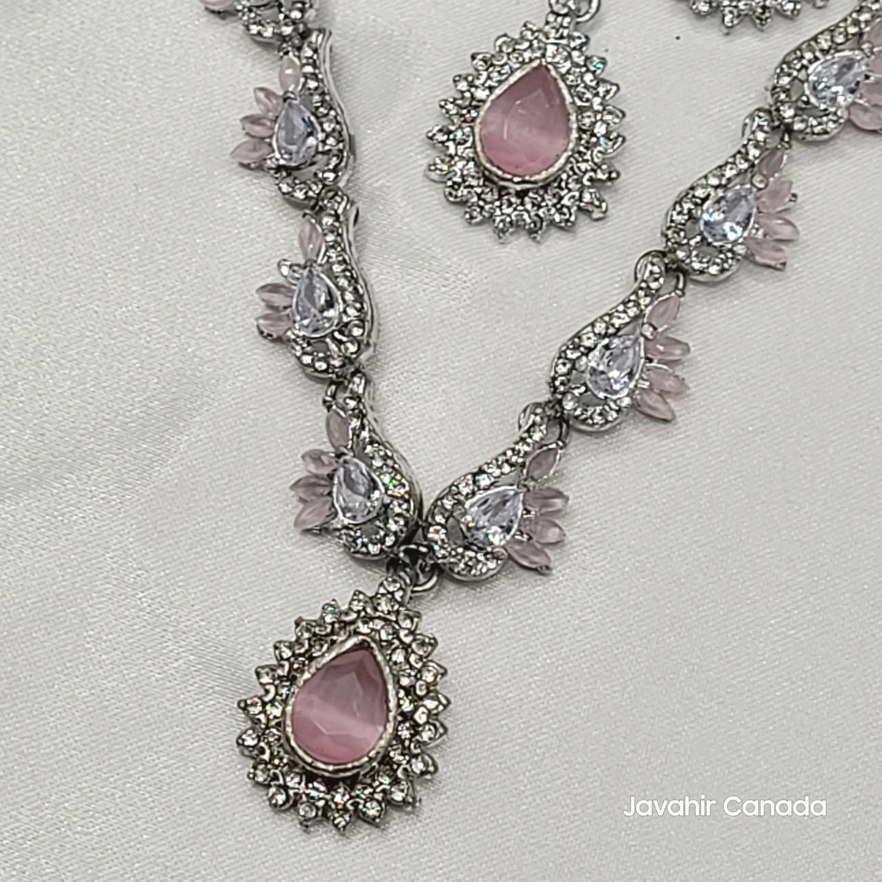 Necklace with pink teardrop-shaped stones on a light gray background