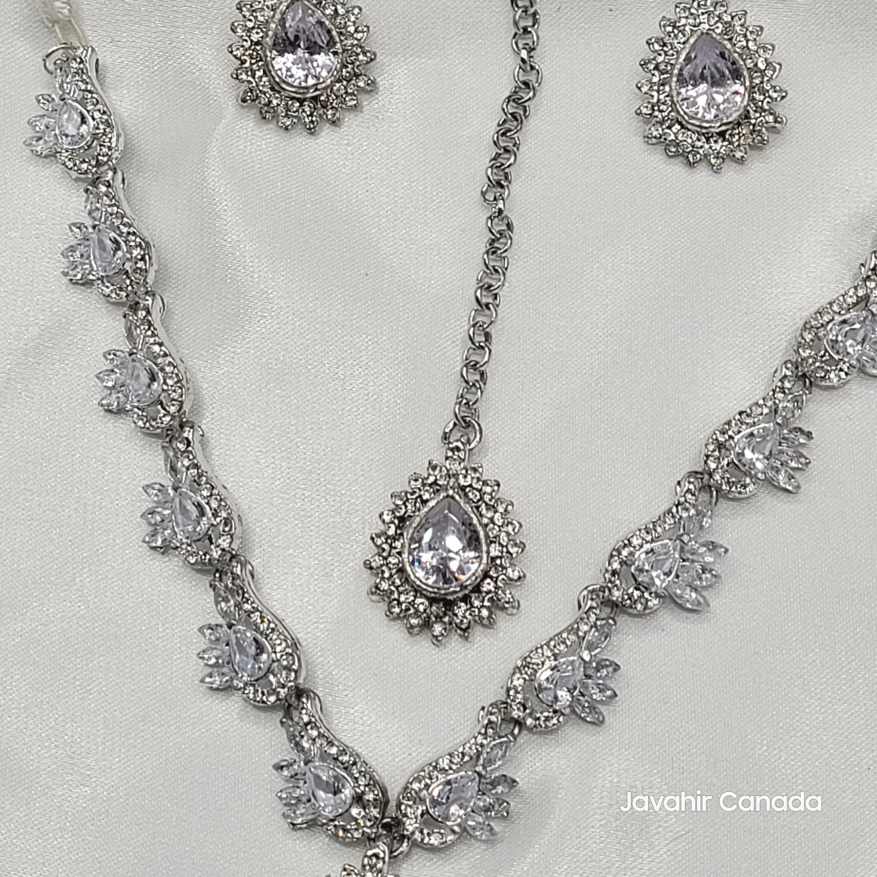Silver necklace and earrings set on a white satin background with 'Javahir Canada' branding.