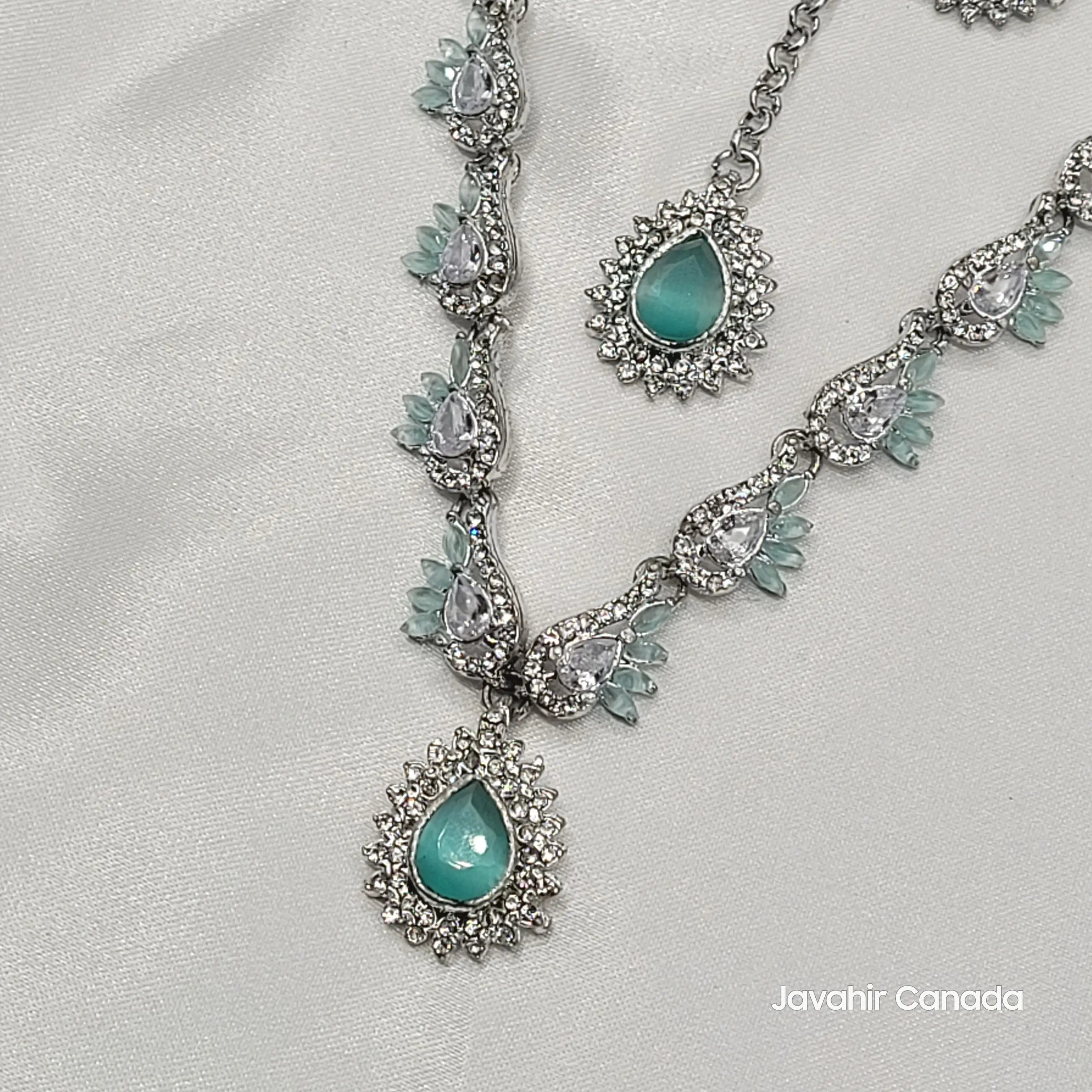 Jewelry set with turquoise stones and silver accents on a white background