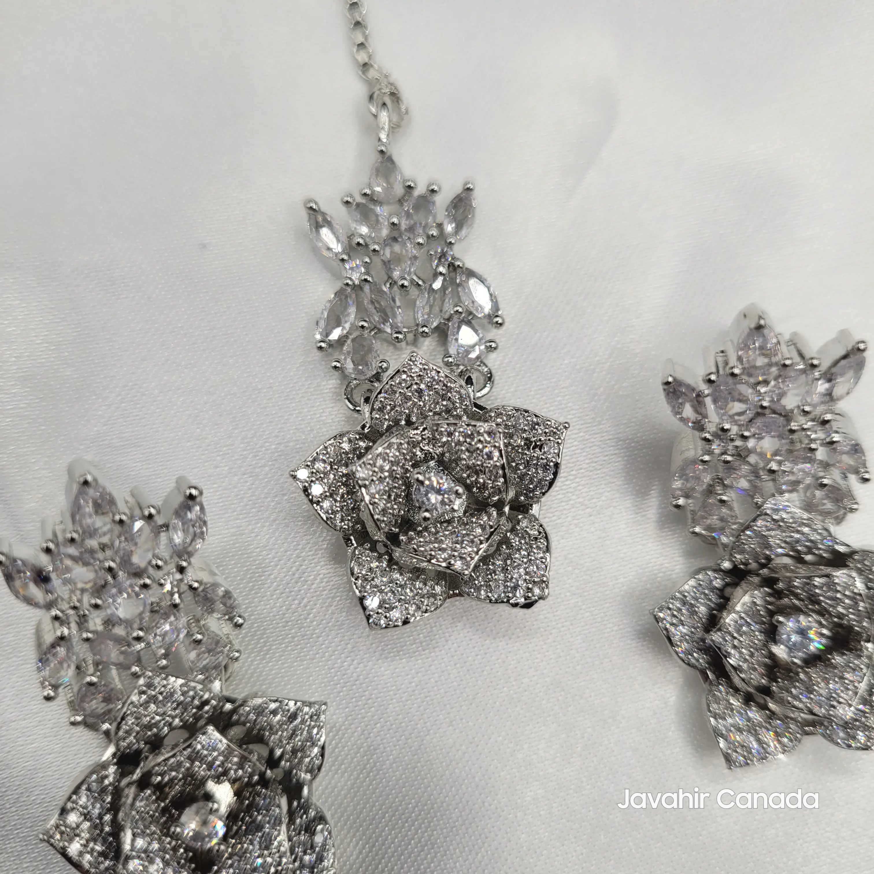 Detailed view of the JV144 floral teeka, highlighting the layered zircon and rose accents