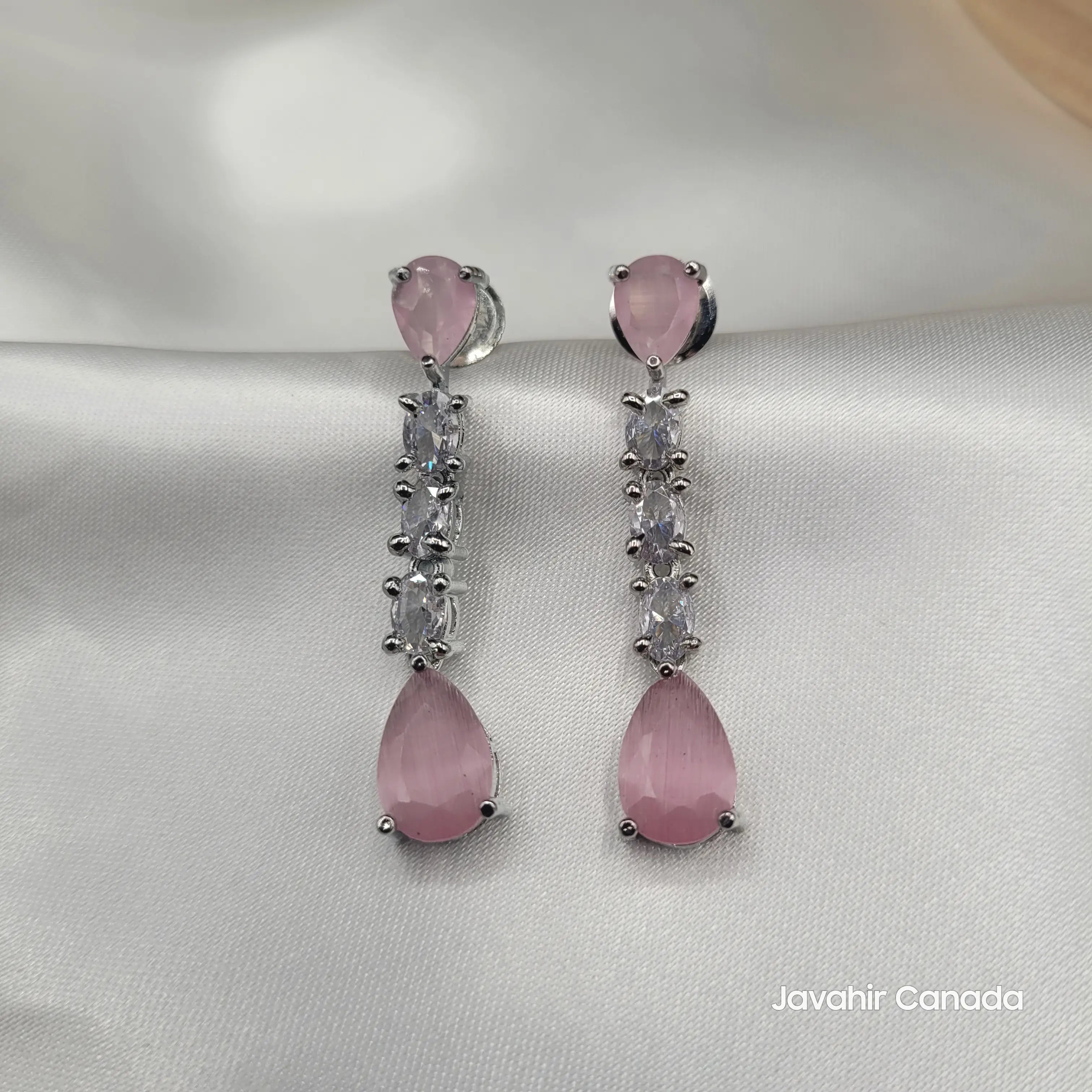 Close-up of JV145 rose pink teardrop earrings paired with sparkling zircon stones.