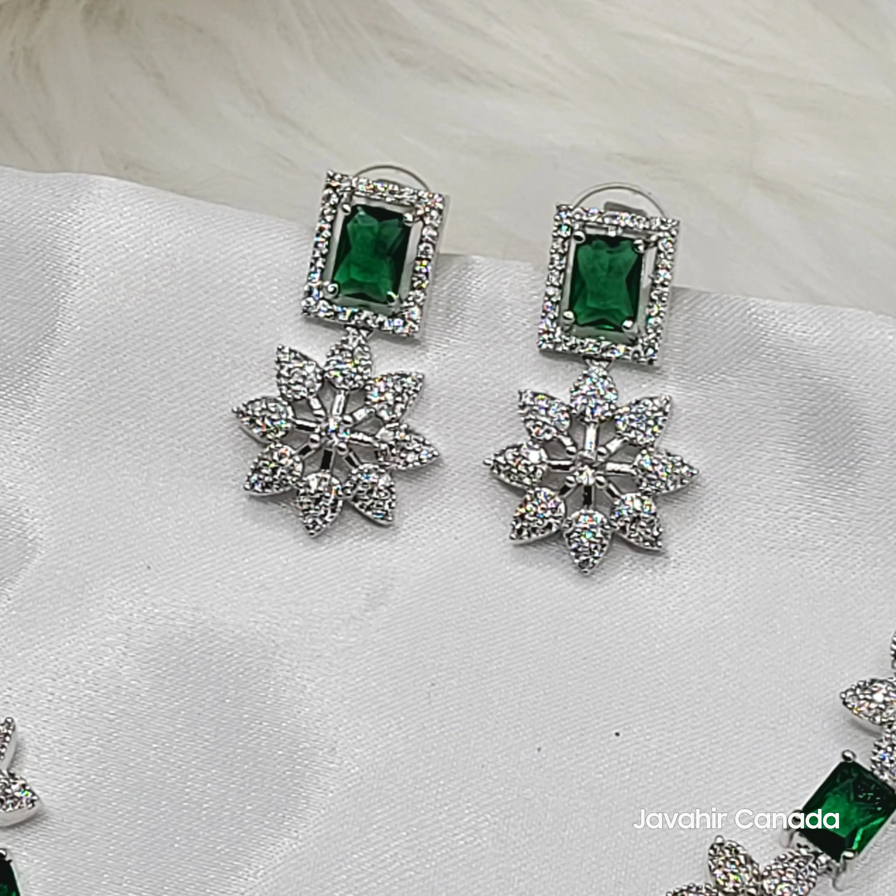 Close-up of emerald green CZ earrings with floral studded drops from JV146 set.