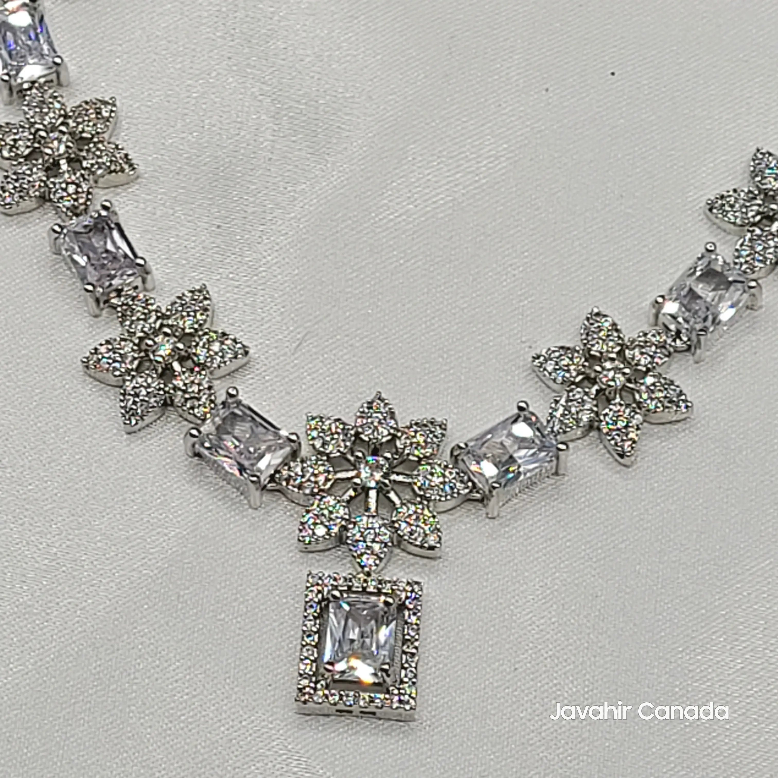 Close-up of classic white CZ necklace set with floral studded drops from JV146 set.