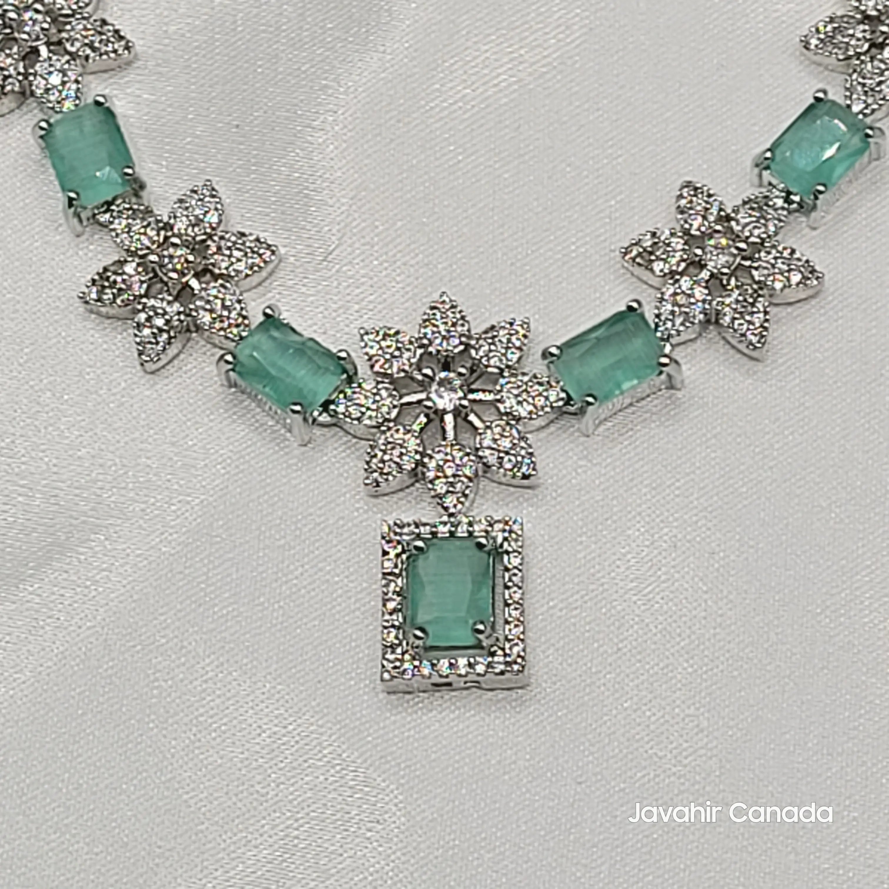 JV146 mint green CZ stone necklace set on silver with intricate floral embellishments.